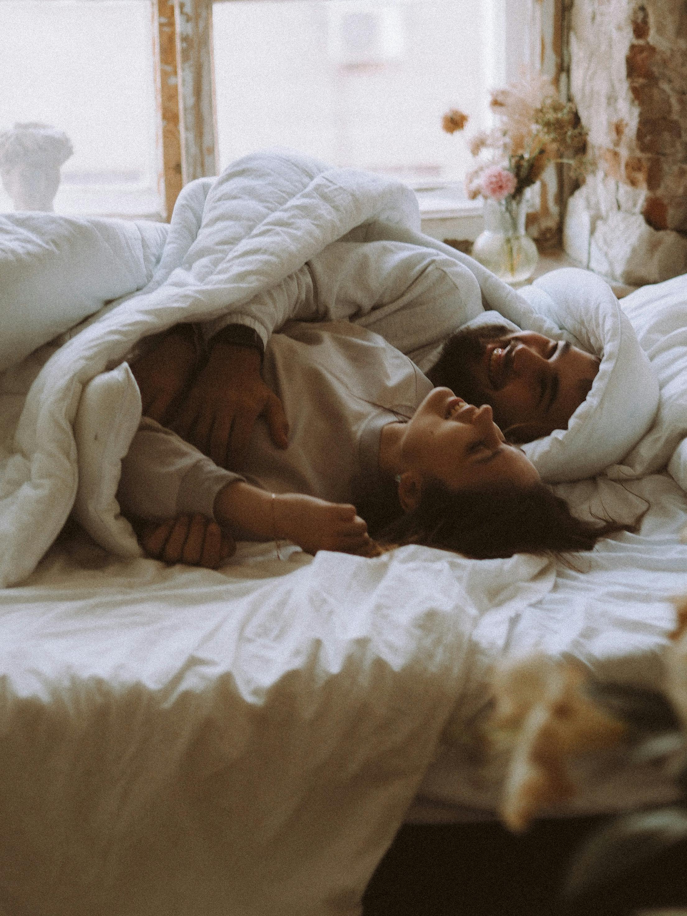 Un couple allongé sur un lit | Source : Pexels