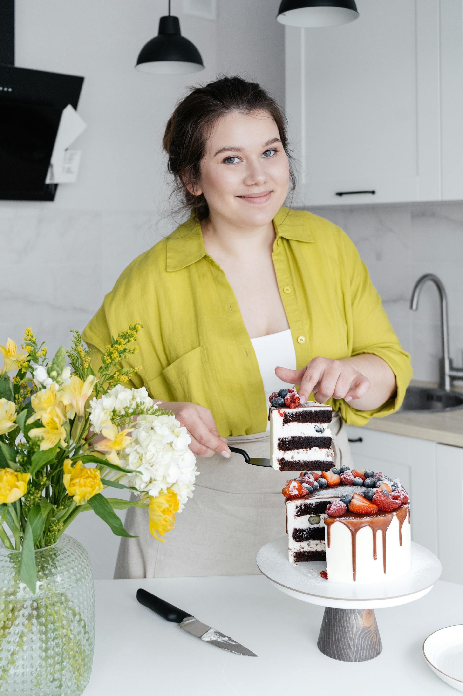 Une femme souriante qui sert un gâteau | Source : Pexels