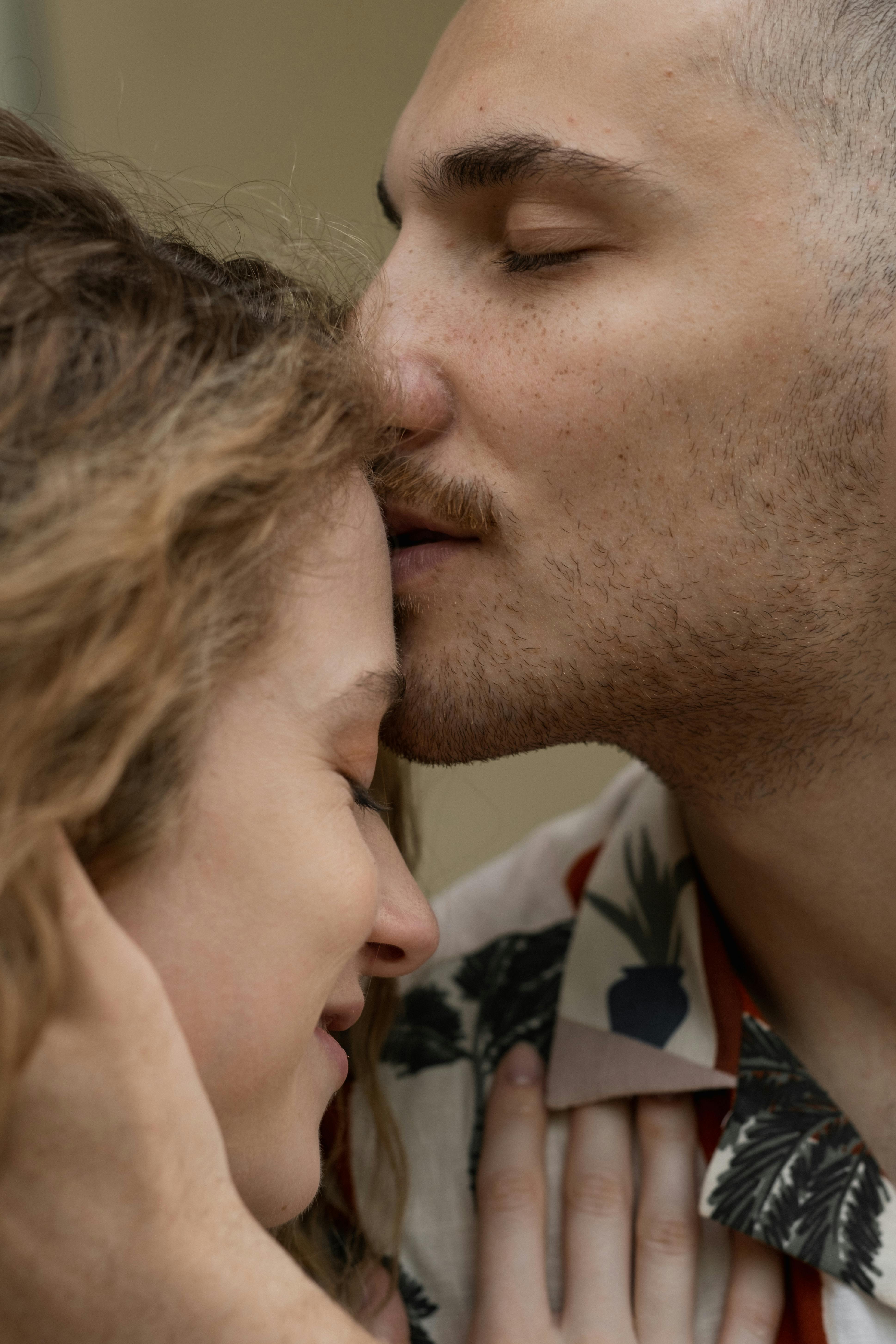 Un homme embrassant le front d'une femme | Source : Pexels