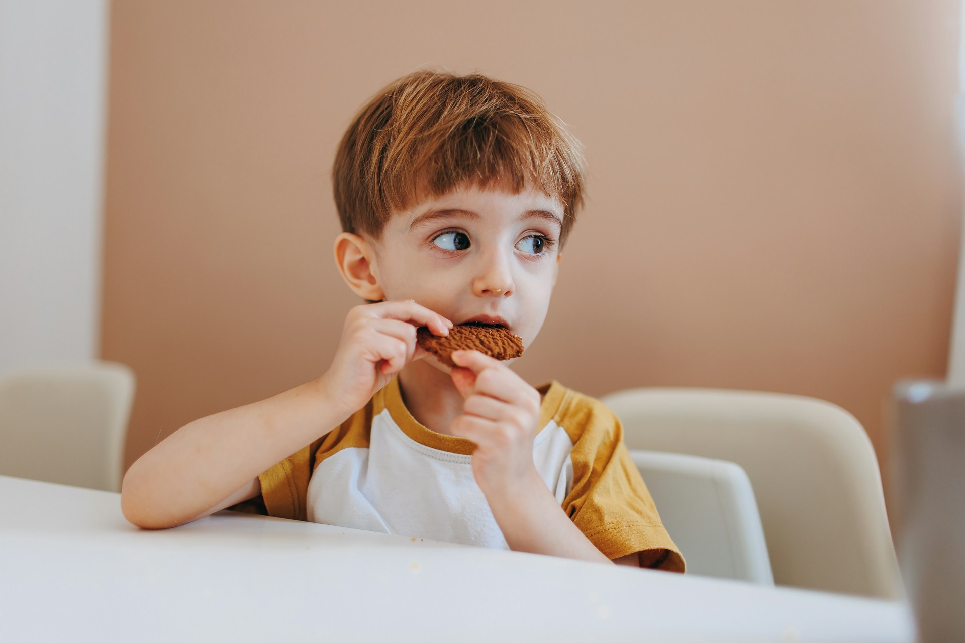 Un petit garçon qui mange son goûter | Source : Unsplash