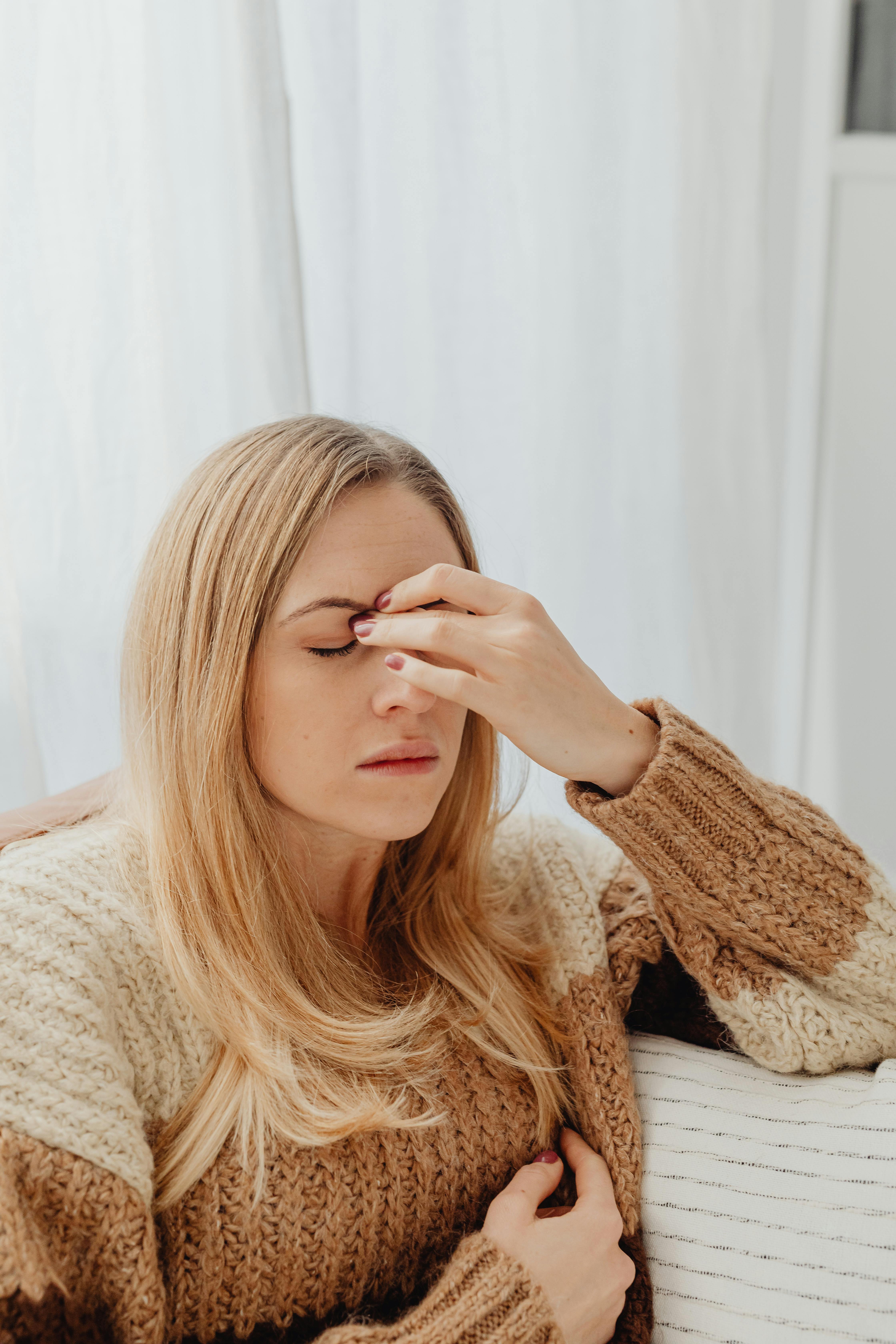 Une femme se tenant l’arête de son nez | Source : Pexels