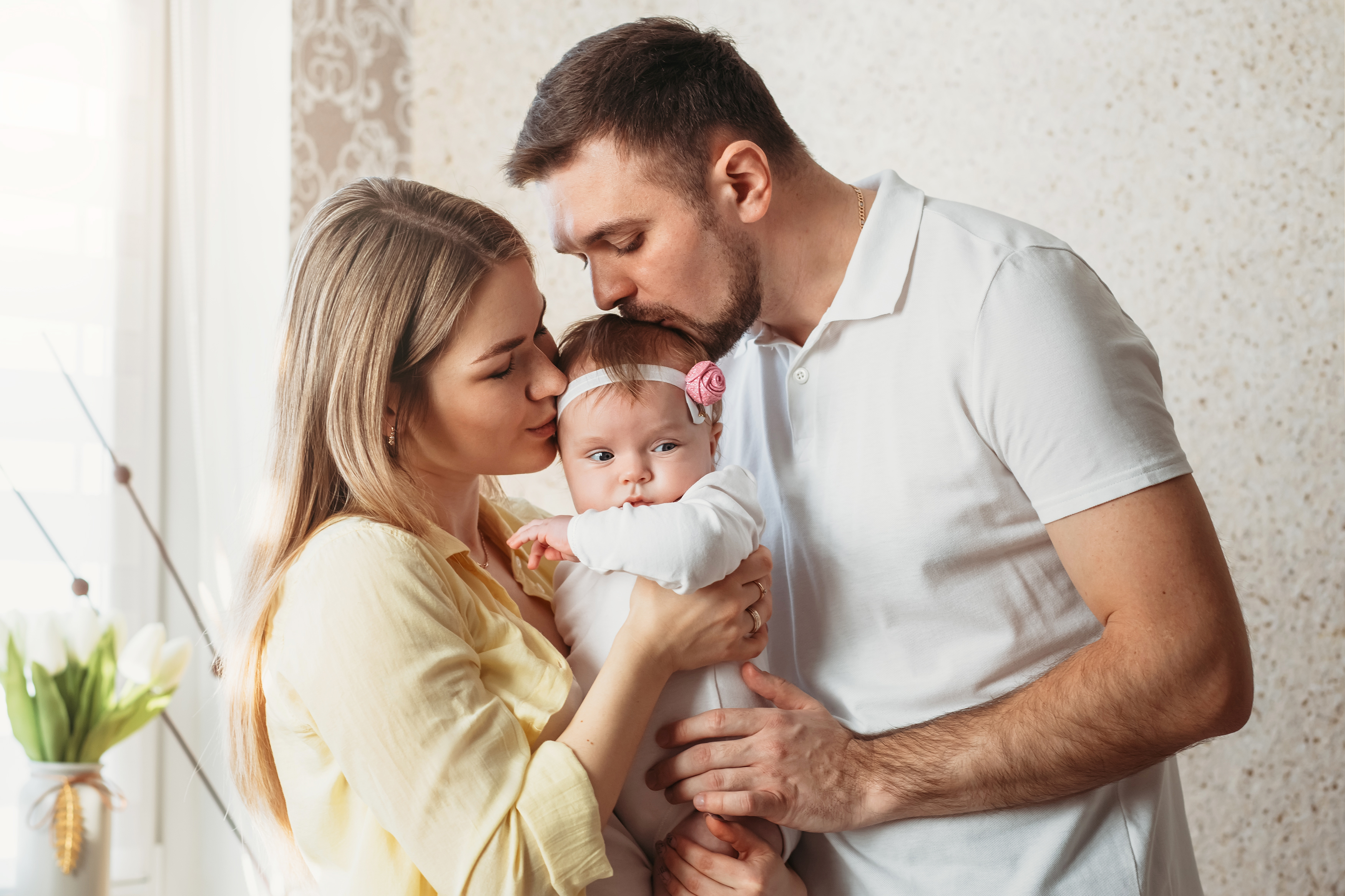 Un couple embrassant son nouveau-né | Source : Shutterstock