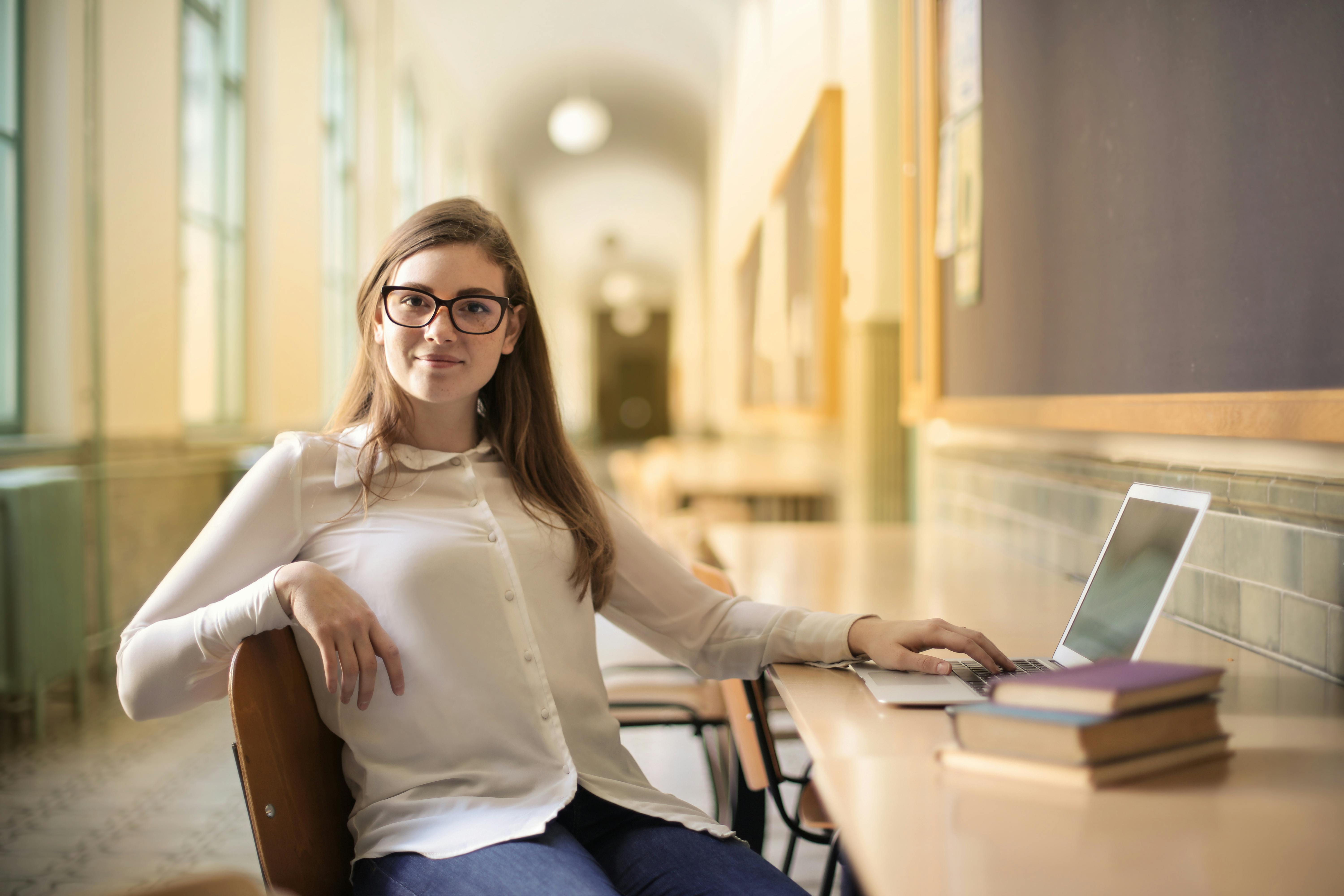 Femme souriante assise sur une chaise | Source : Pexels