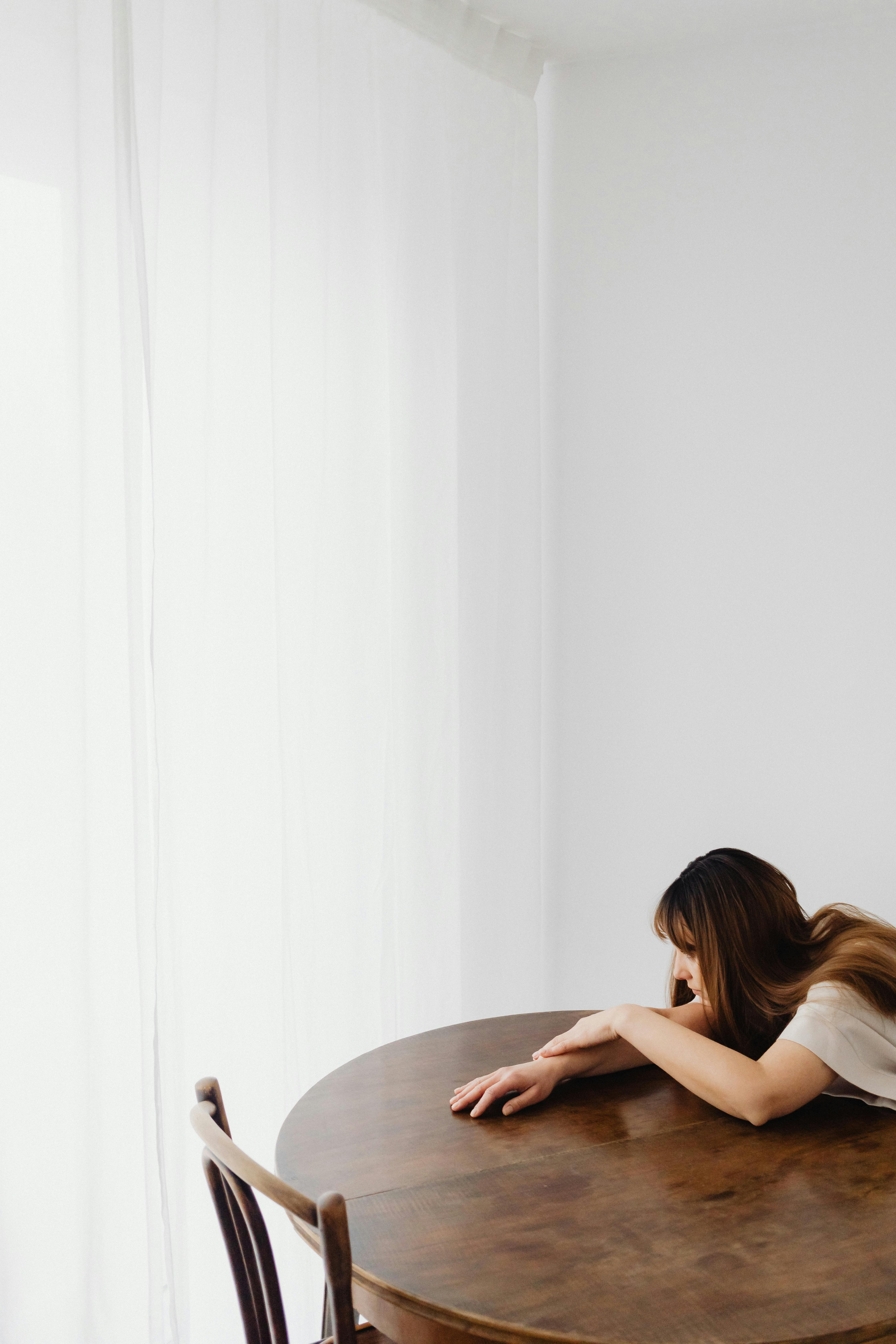 Une femme appuyée sur une table | Source : Pexels
