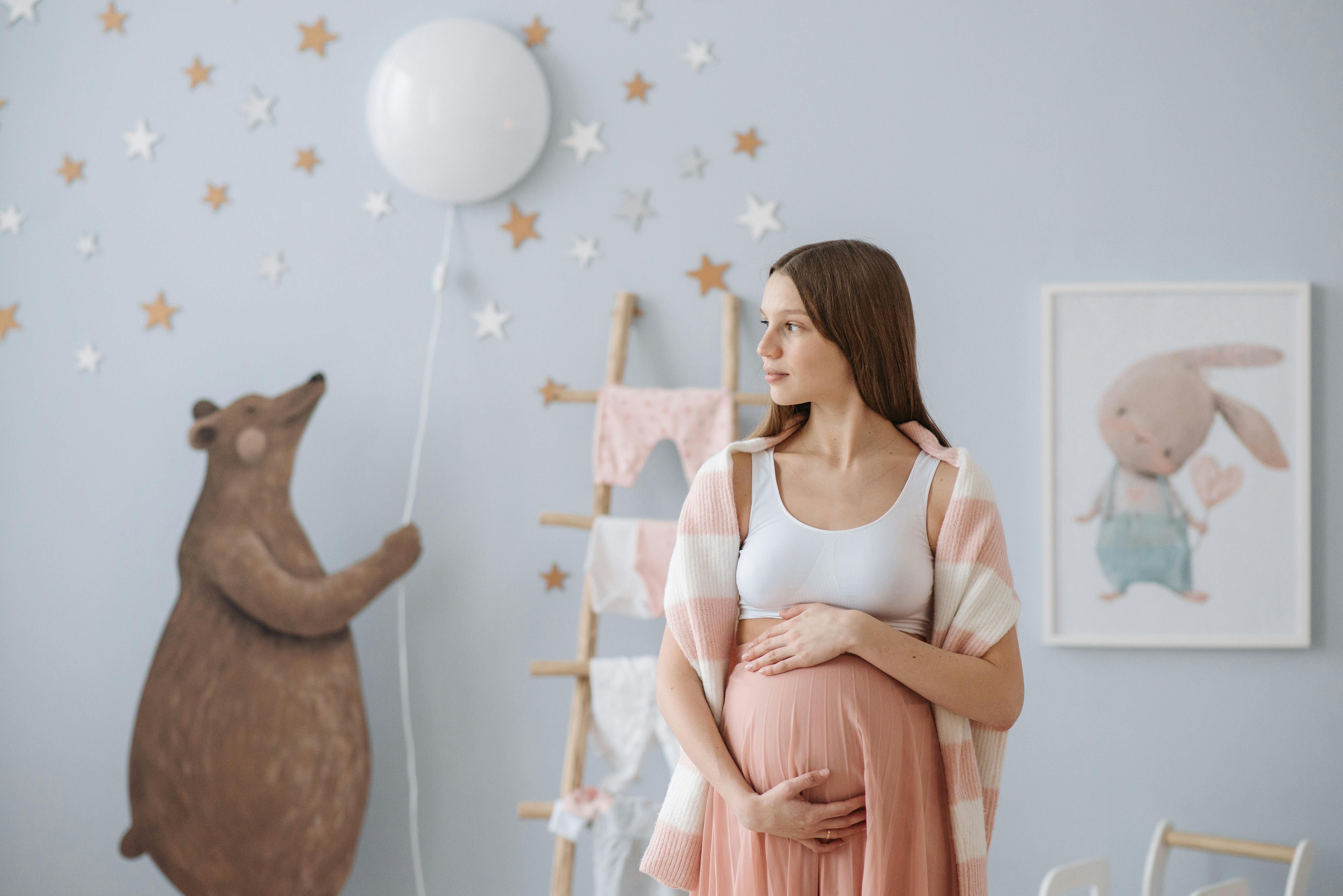 Une femme enceinte debout dans une chambre d'enfant | Source : Pexels