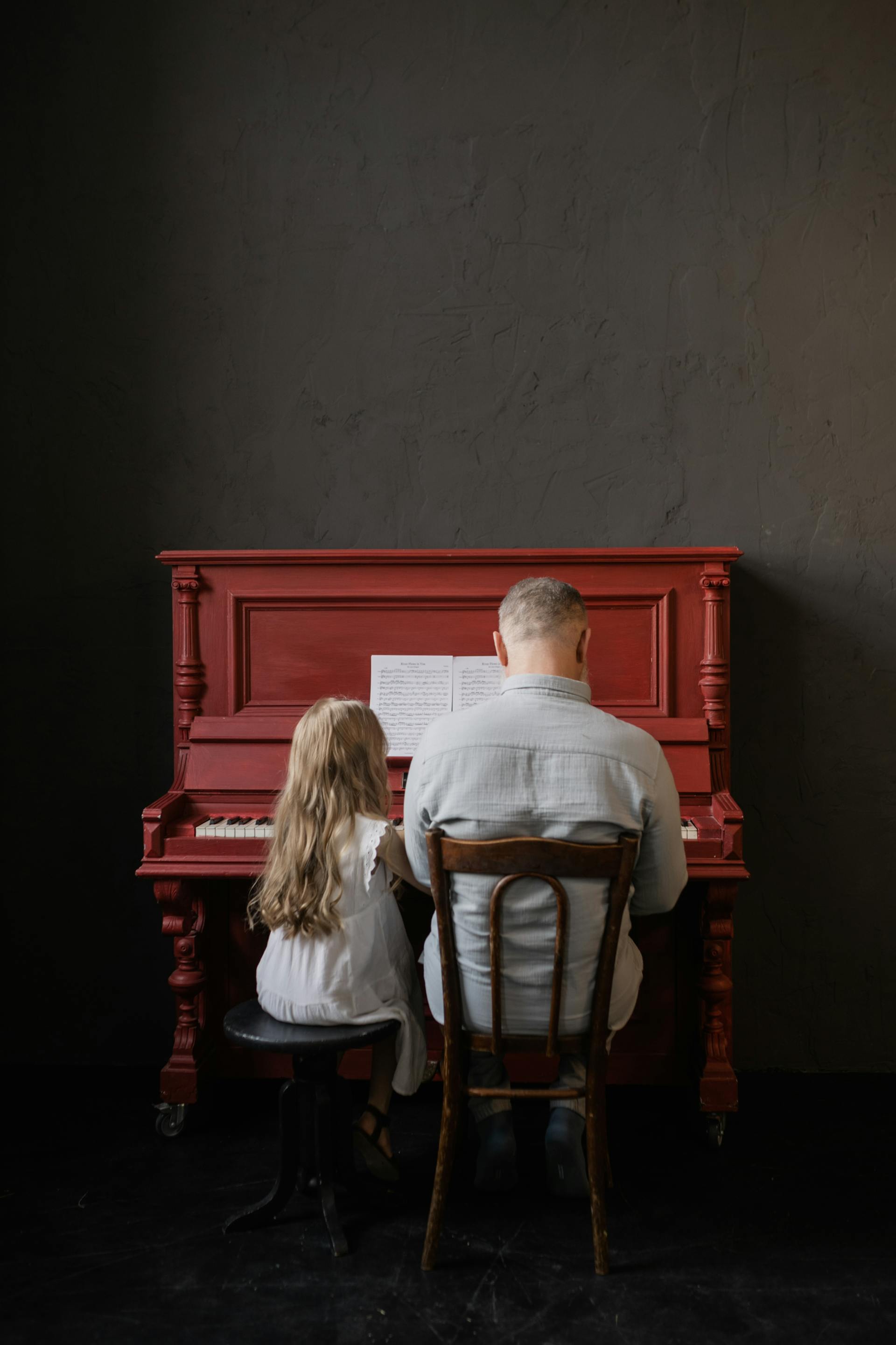 Un homme âgé qui joue du piano avec une jeune fille | Source : Pexels