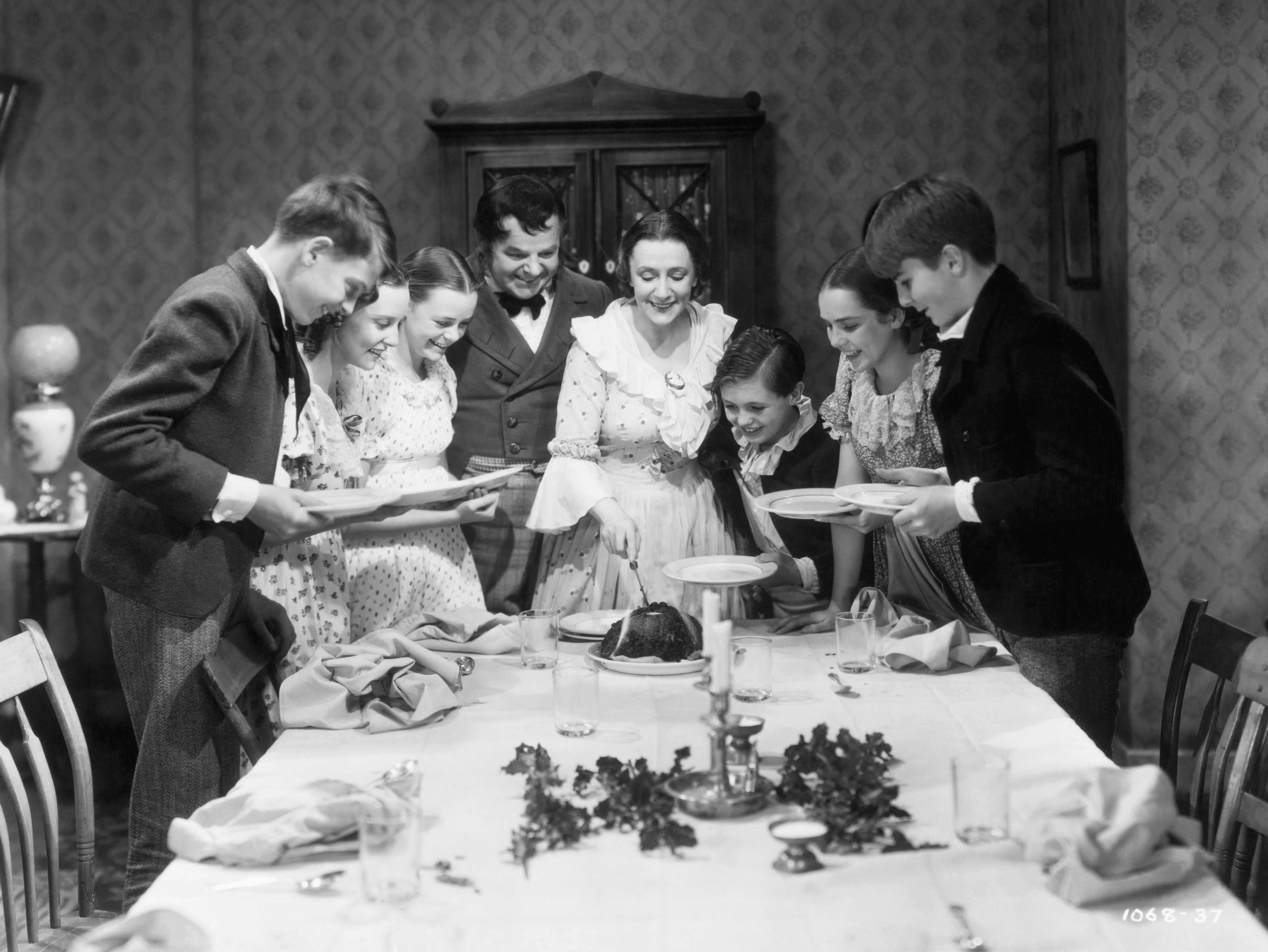 La famille Cratchit lors du repas de Noël dans une scène tirée du film « A Christmas Carol », réalisé par Edwin L. Marin, vers 1938. À partir de la troisième personne à gauche, June Lockhart, Gene Lockhart, Kathleen Lockhart et Terry Kilburn. | Source : Getty Images