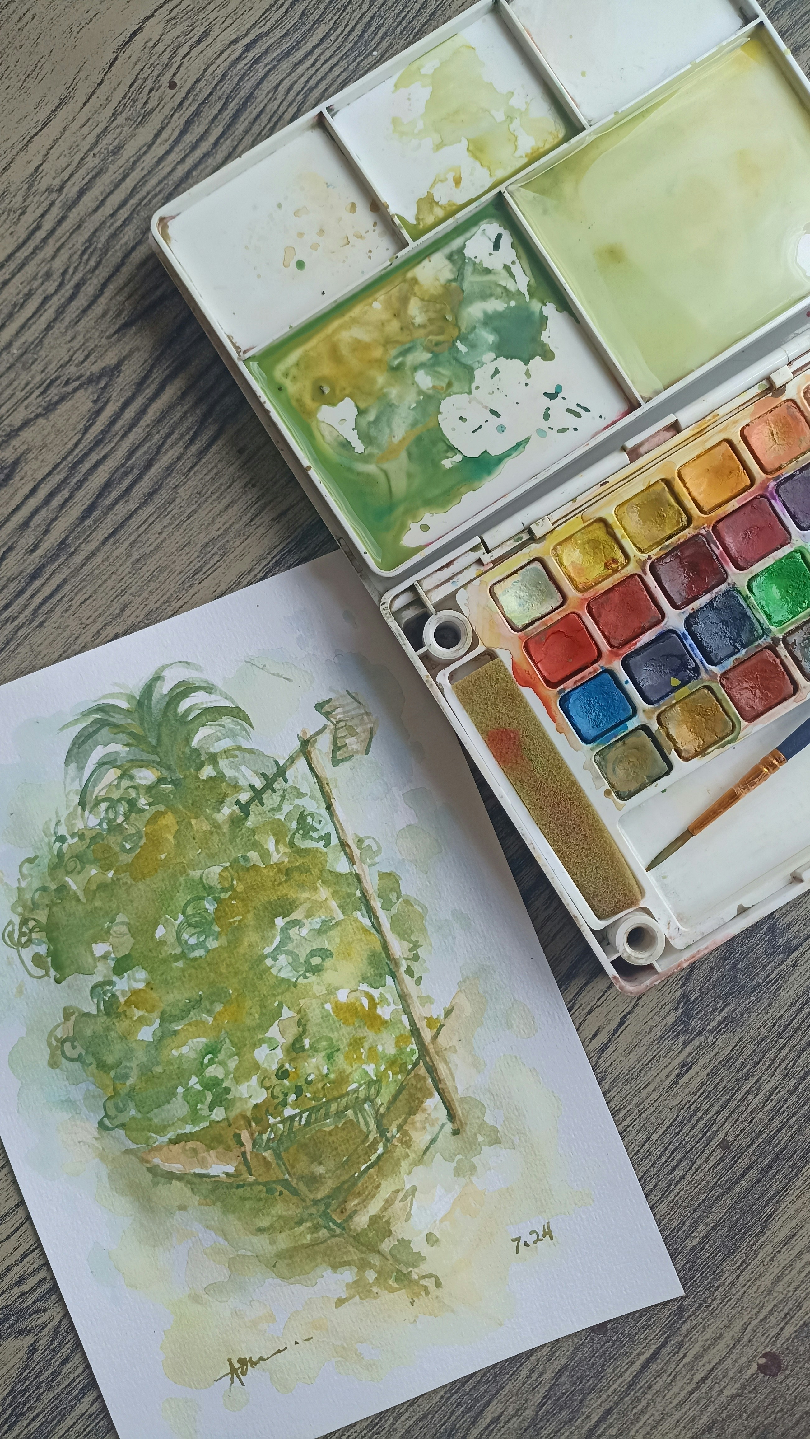 Un set de peinture à l'aquarelle et une œuvre d'art | Source : Unsplash
