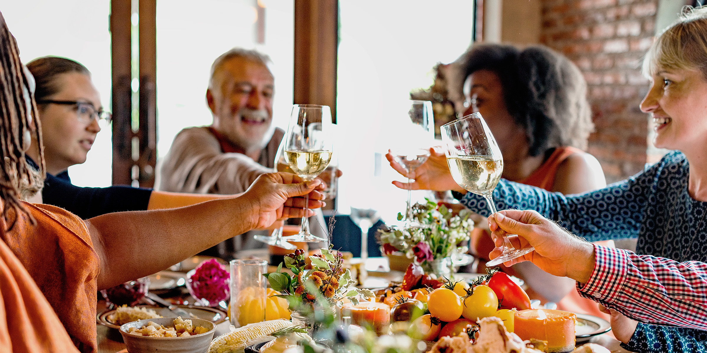 Une famille porte un toast tout en dînant | Source : Shutterstock