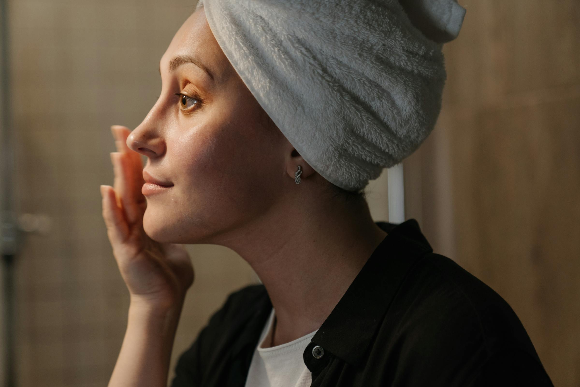 Une femme qui met de la crème sur le visage | Source : Pexels