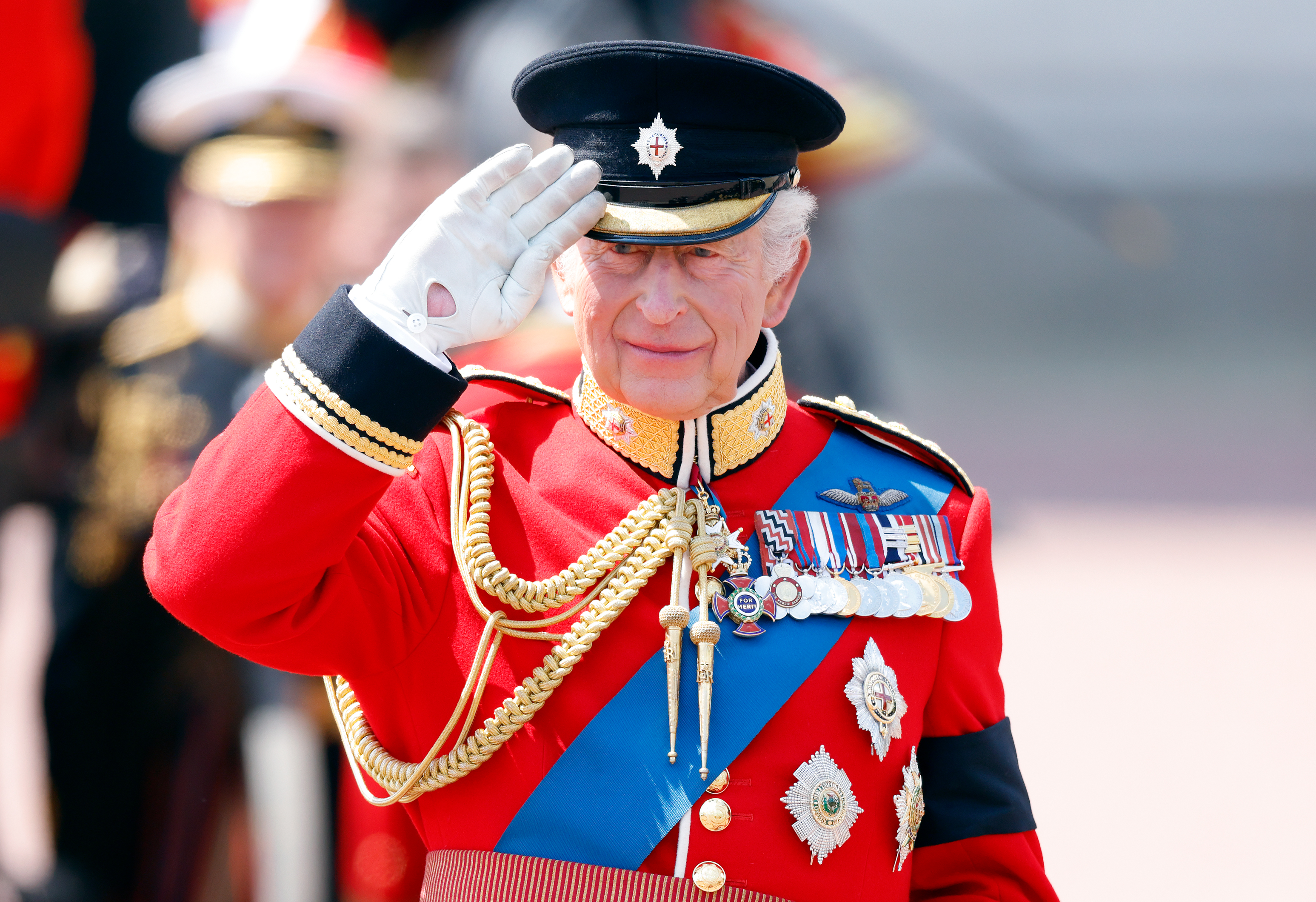 Le roi Charles III fait le salut depuis une estrade à l'extérieur du palais de Buckingham lors de la marche des couleurs 2025 | Source : Getty Images