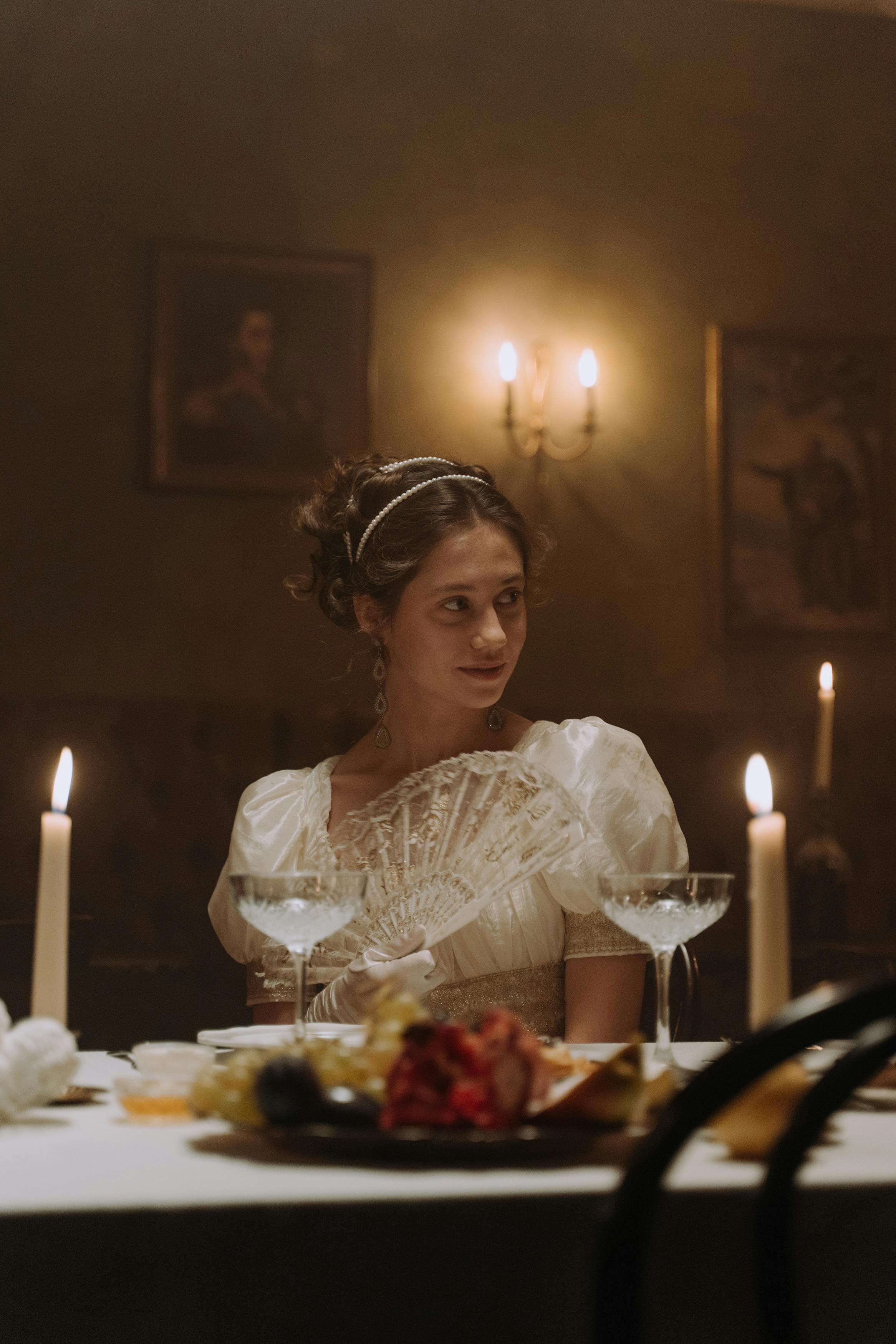 Une femme assise à une table de dîner fixant quelqu'un hors caméra | Source : Pexels