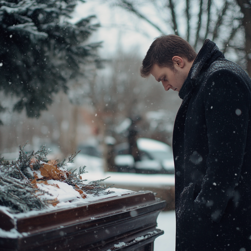 Un homme regardant le cercueil de son père | Source : Midjourney