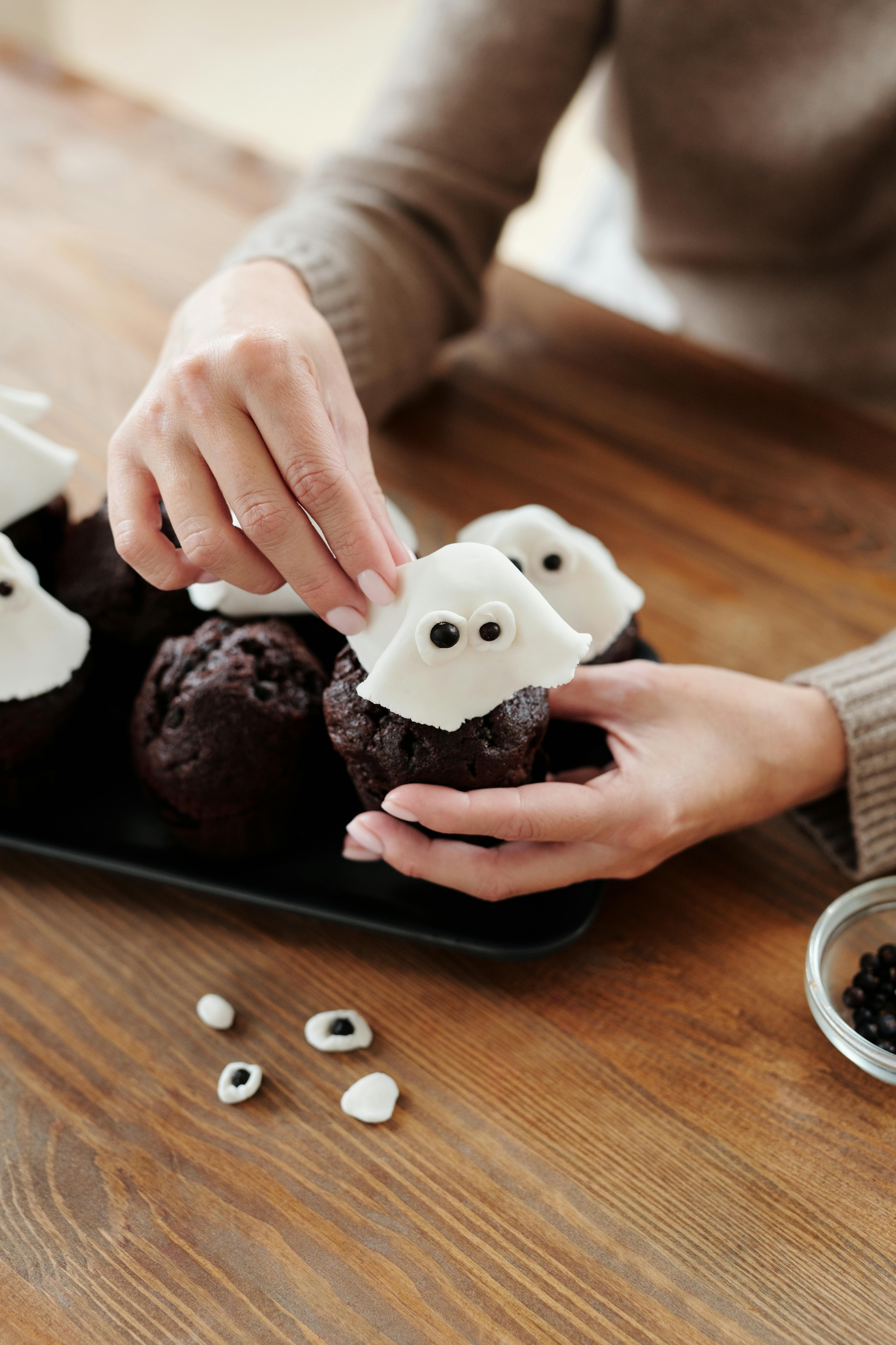 Une femme décorant des petits gâteaux | Source : Pexels
