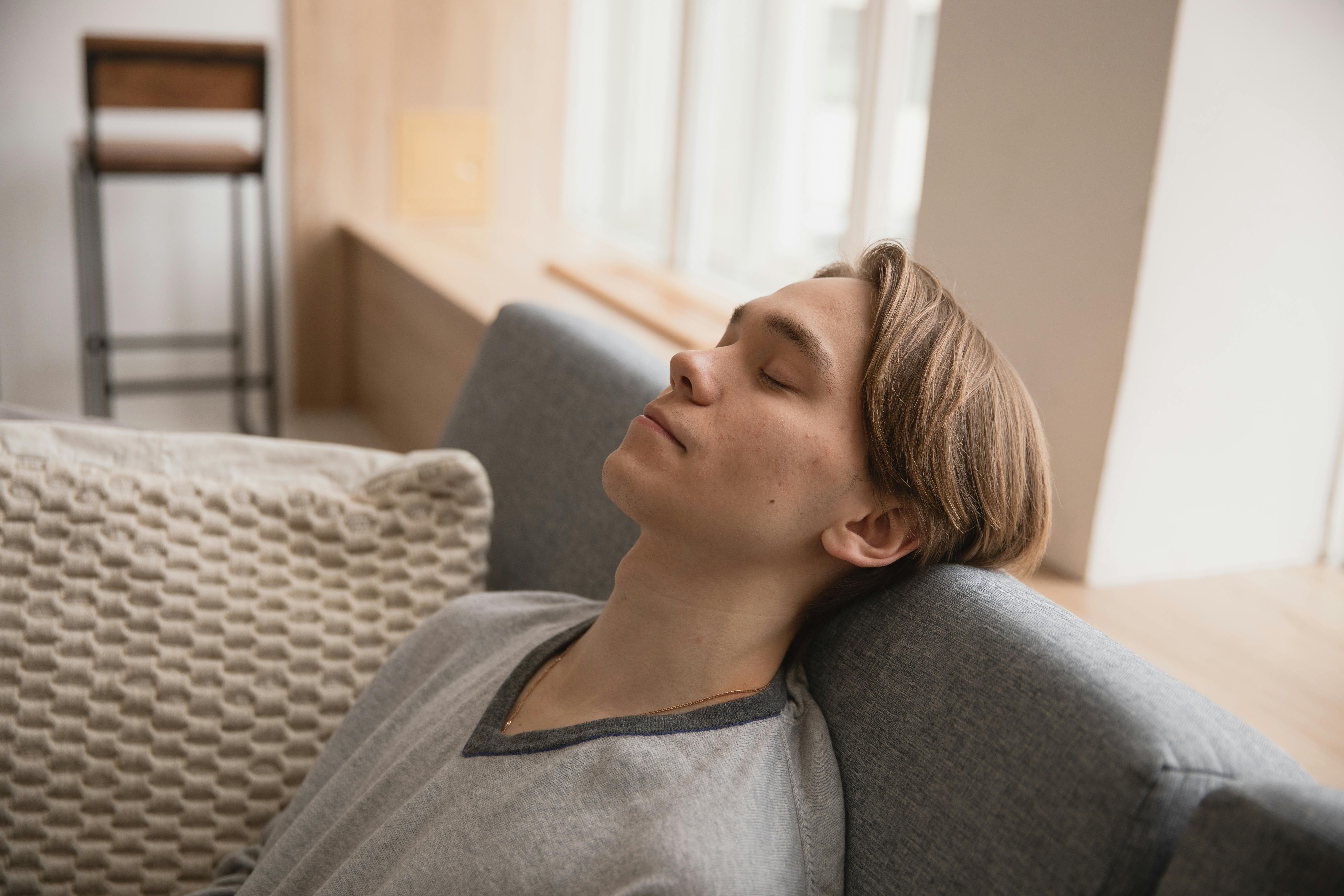 Un homme qui dort sur un canapé | Source : Pexels
