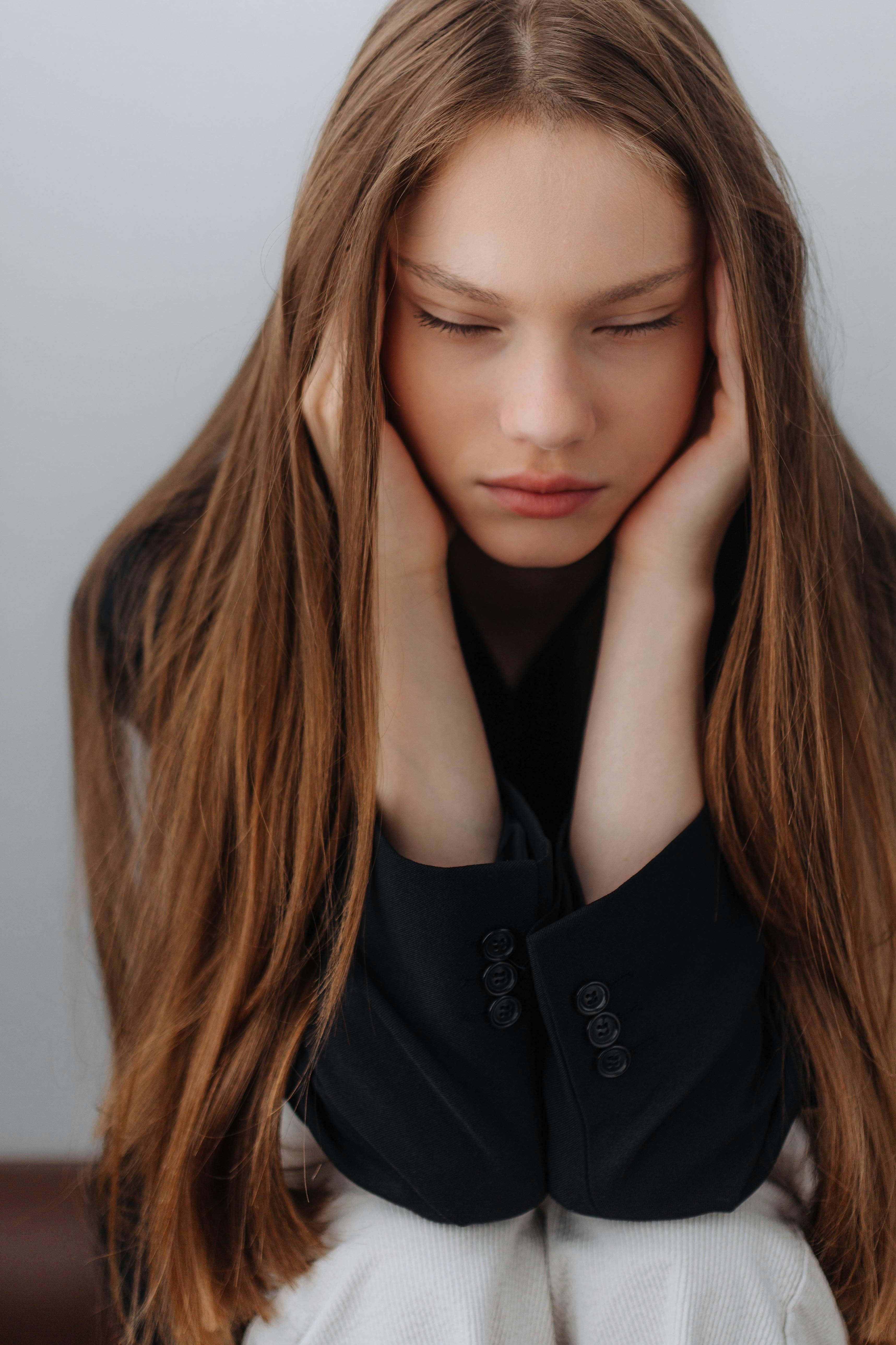 Une jeune femme se couvrant les oreilles | Source : Pexels
