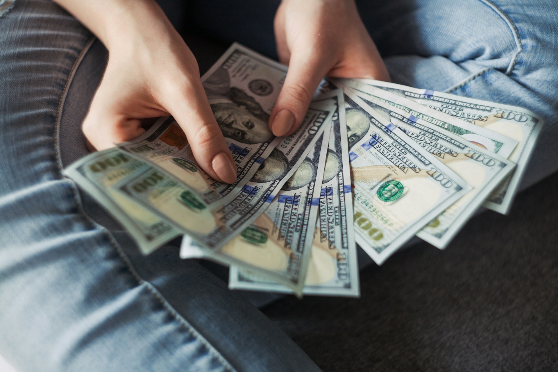 Une jeune femme tenant des billets d'un dollar | Source : Unsplash