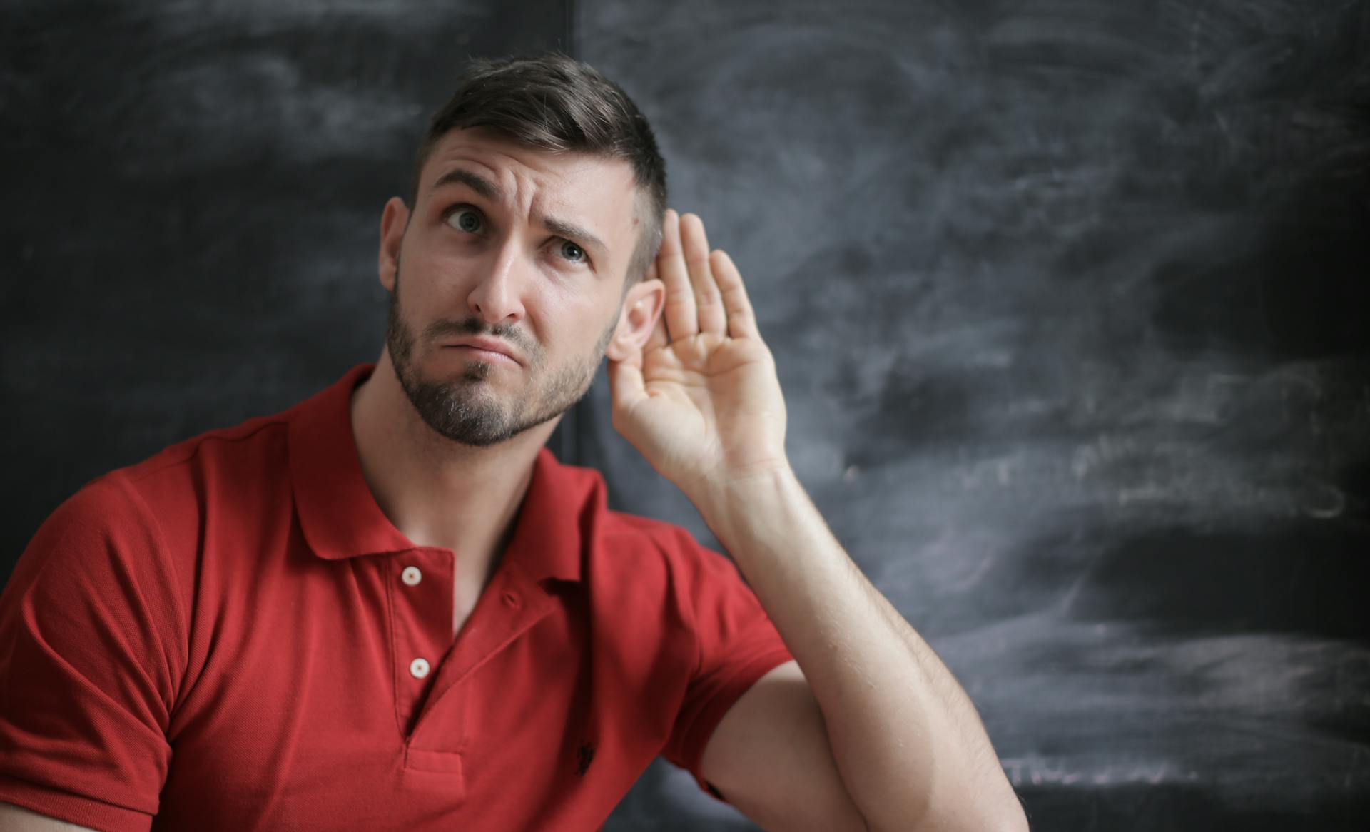 Un homme avec sa main placée derrière son oreille | Source : Pexels