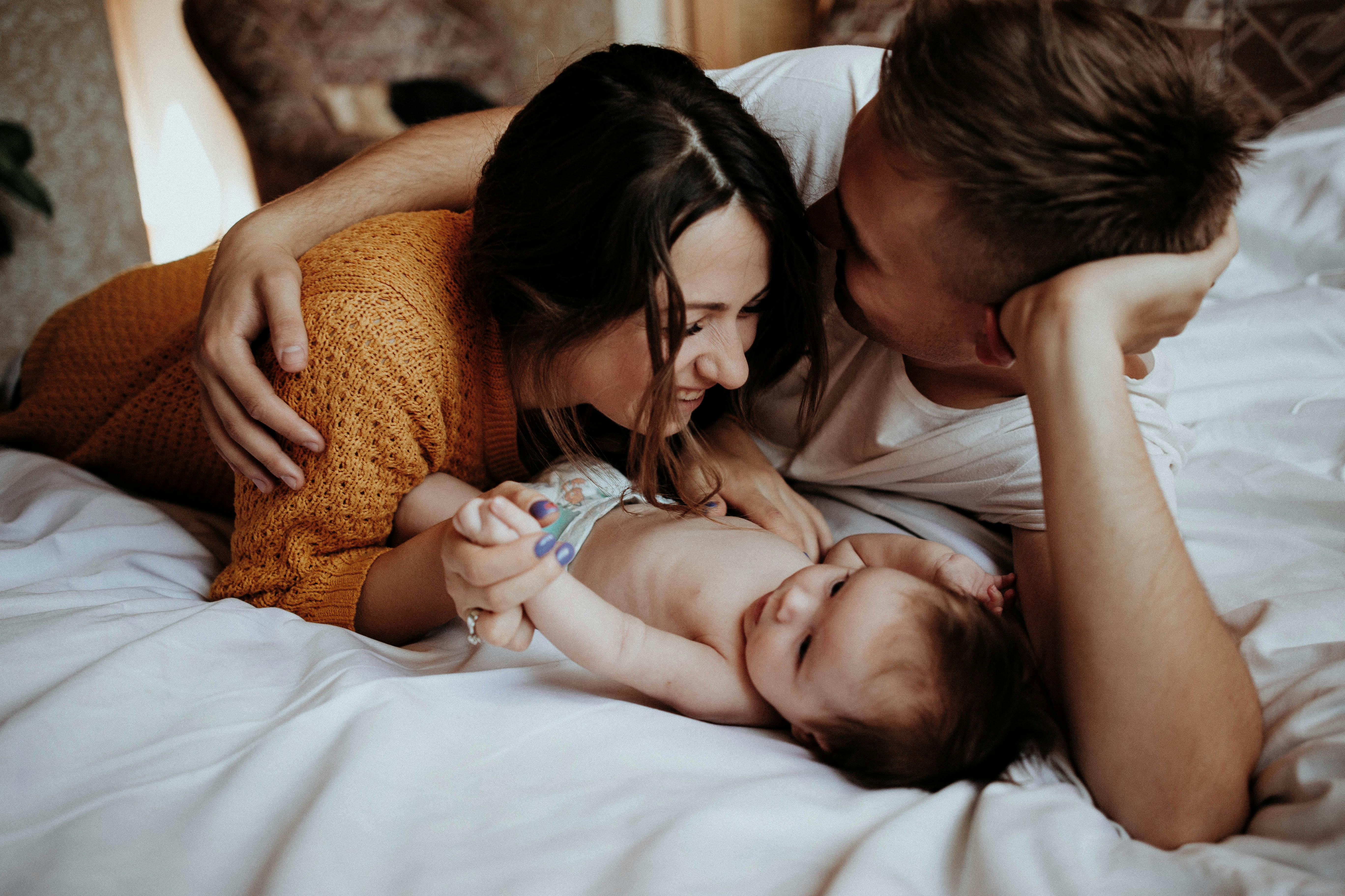 Un couple heureux qui s'attache à son bébé | Source : Pexels