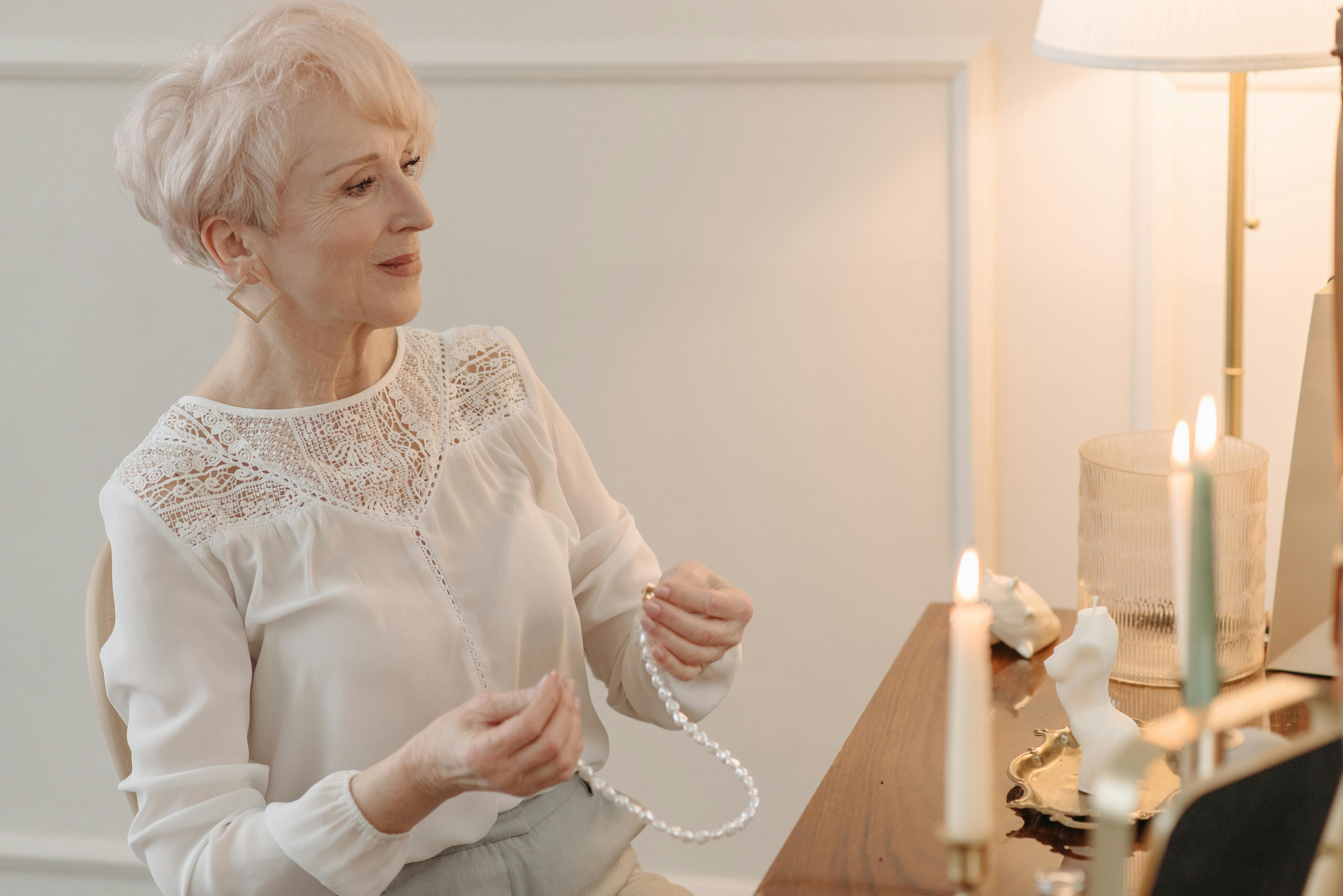 Une vieille femme assise devant sa commode | Source : Pexels