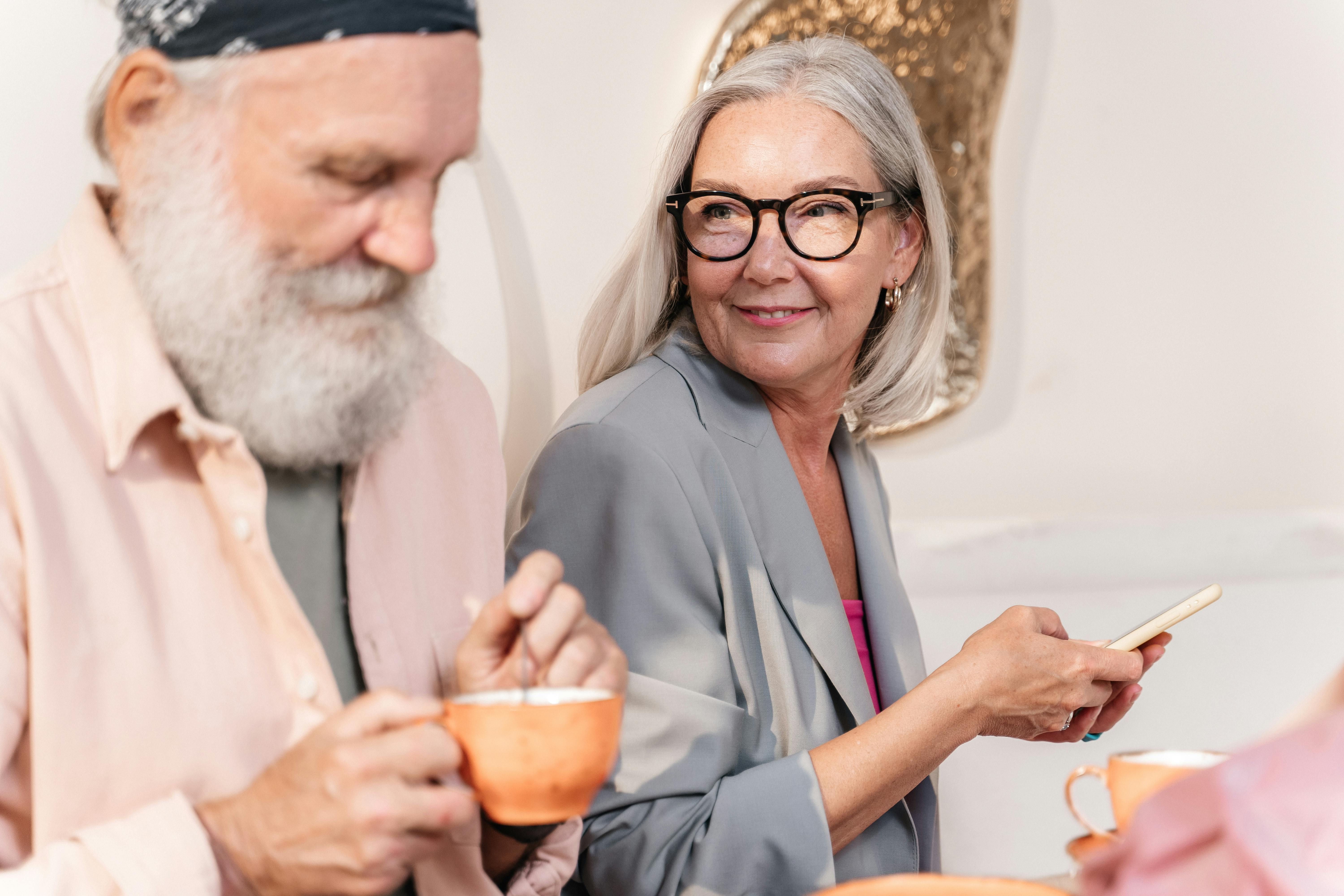 Un couple de personnes âgées dégustant des boissons chaudes | Source : Pexels