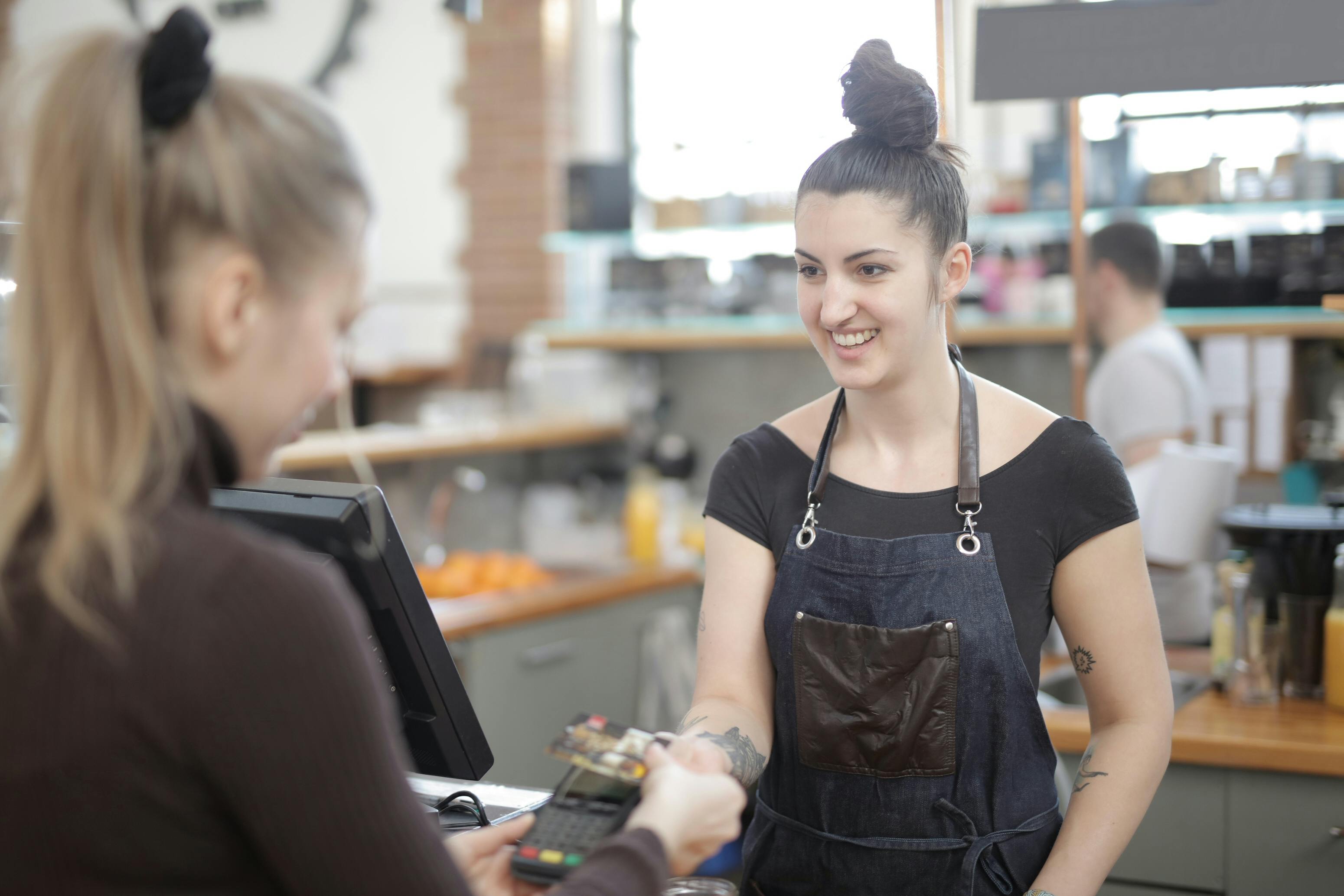 Une caissière aidant un client à payer | Source : Pexels