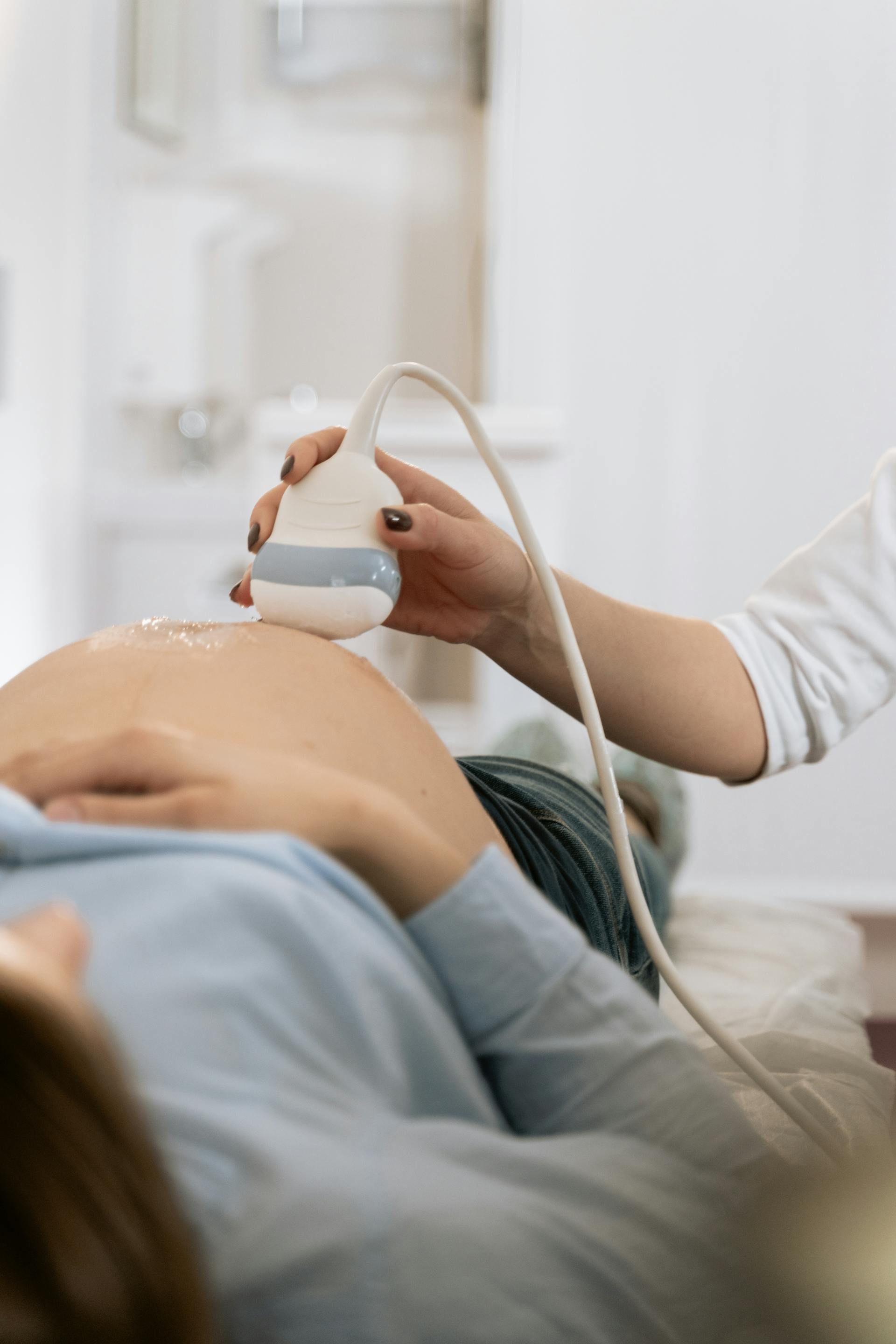 Une femme enceinte allongée qui se fait faire une échographie | Source : Pexels