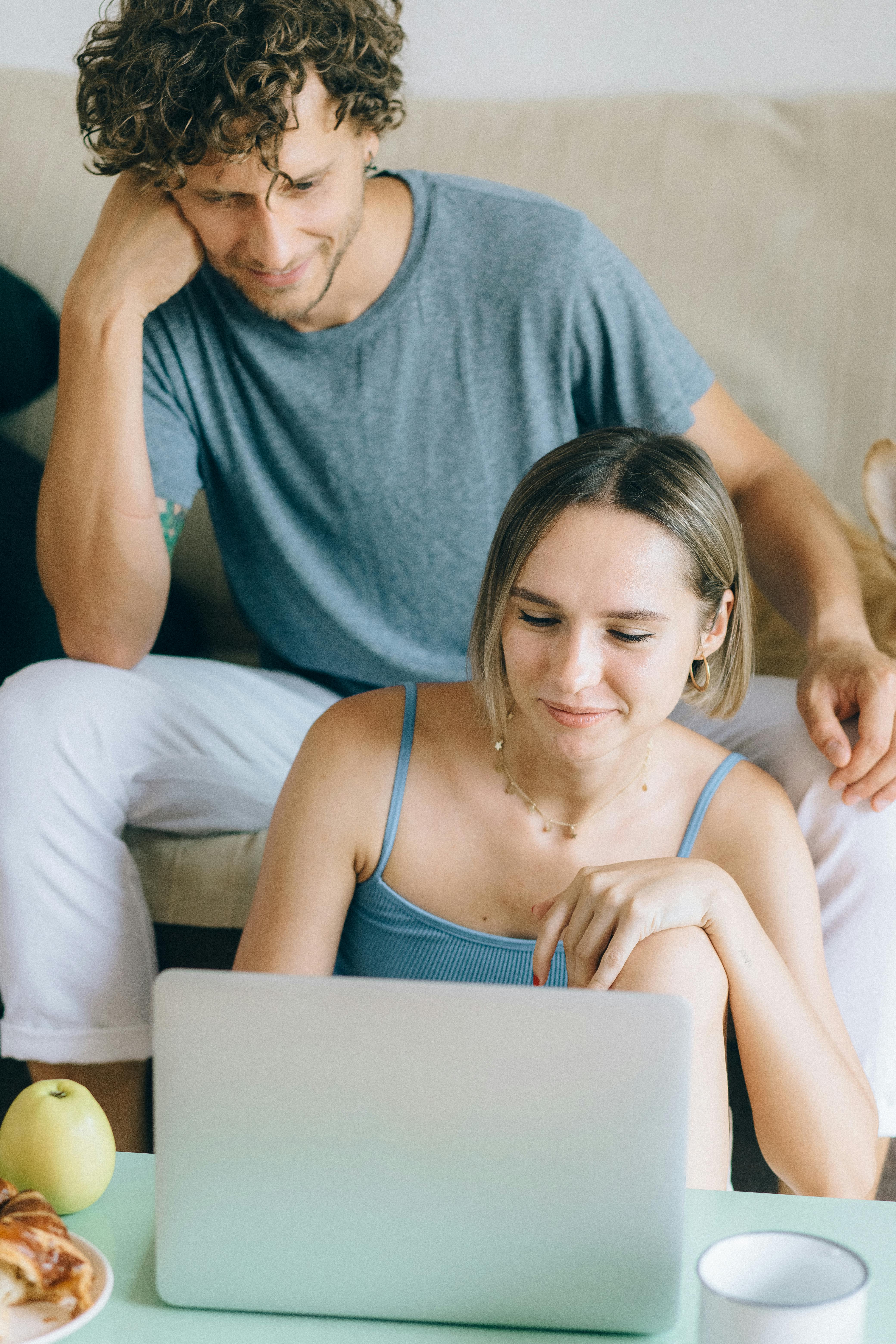 Un couple à la maison regardant un ordinateur portable | Source : Pexels