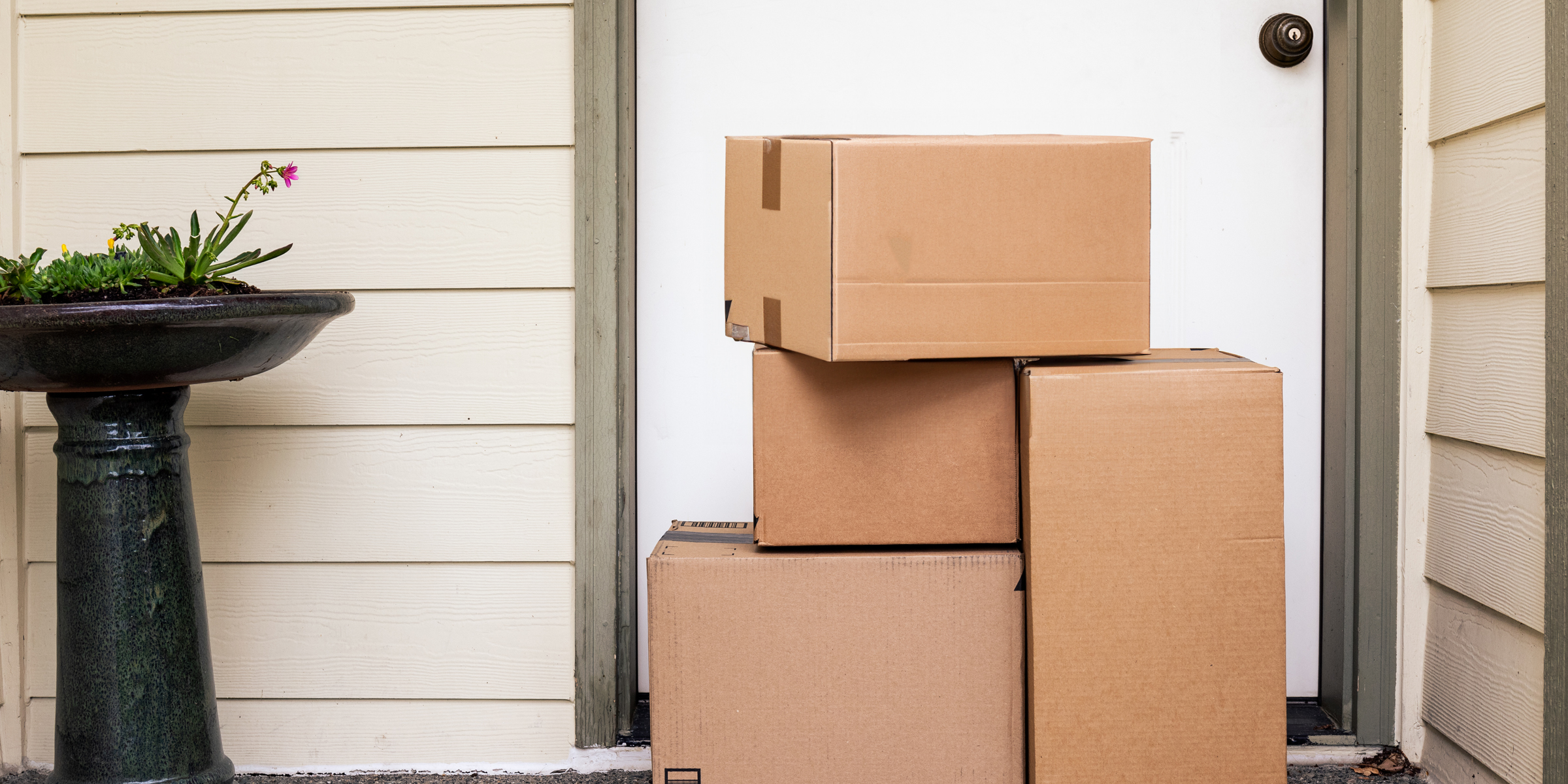 Des boîtes en carton devant une porte d'entrée | Source : Shutterstock