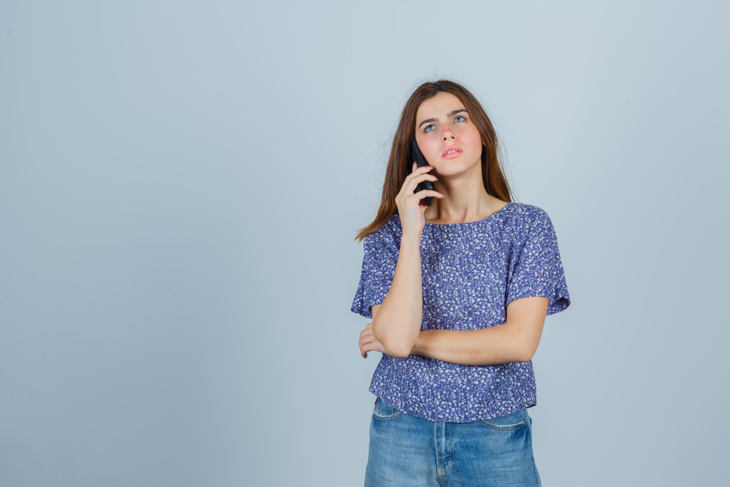 Une femme inquiète parle au téléphone | Source : Freepik