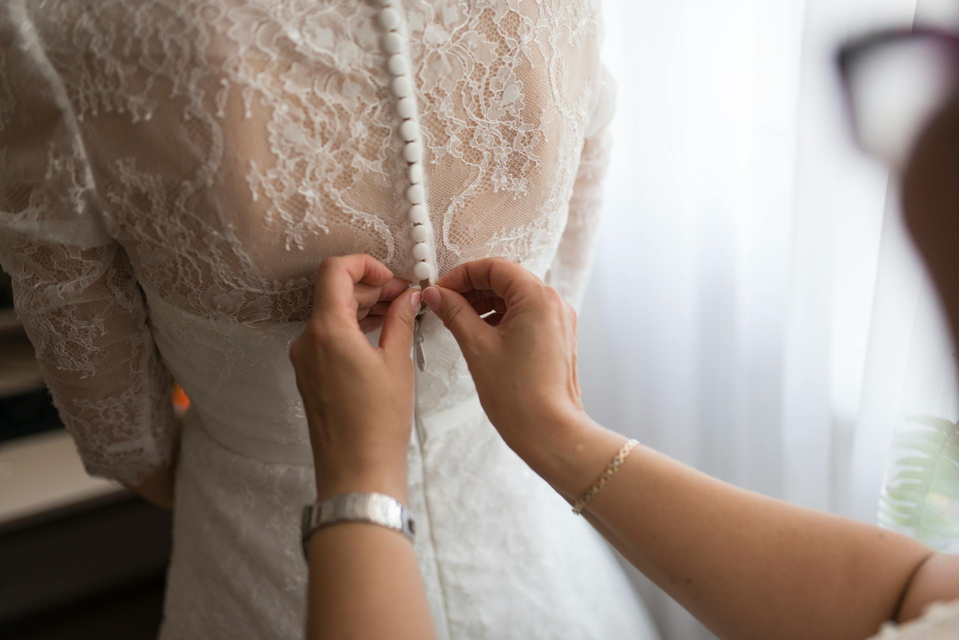 Une femme aidant une mariée avec sa robe | Source : Pexels