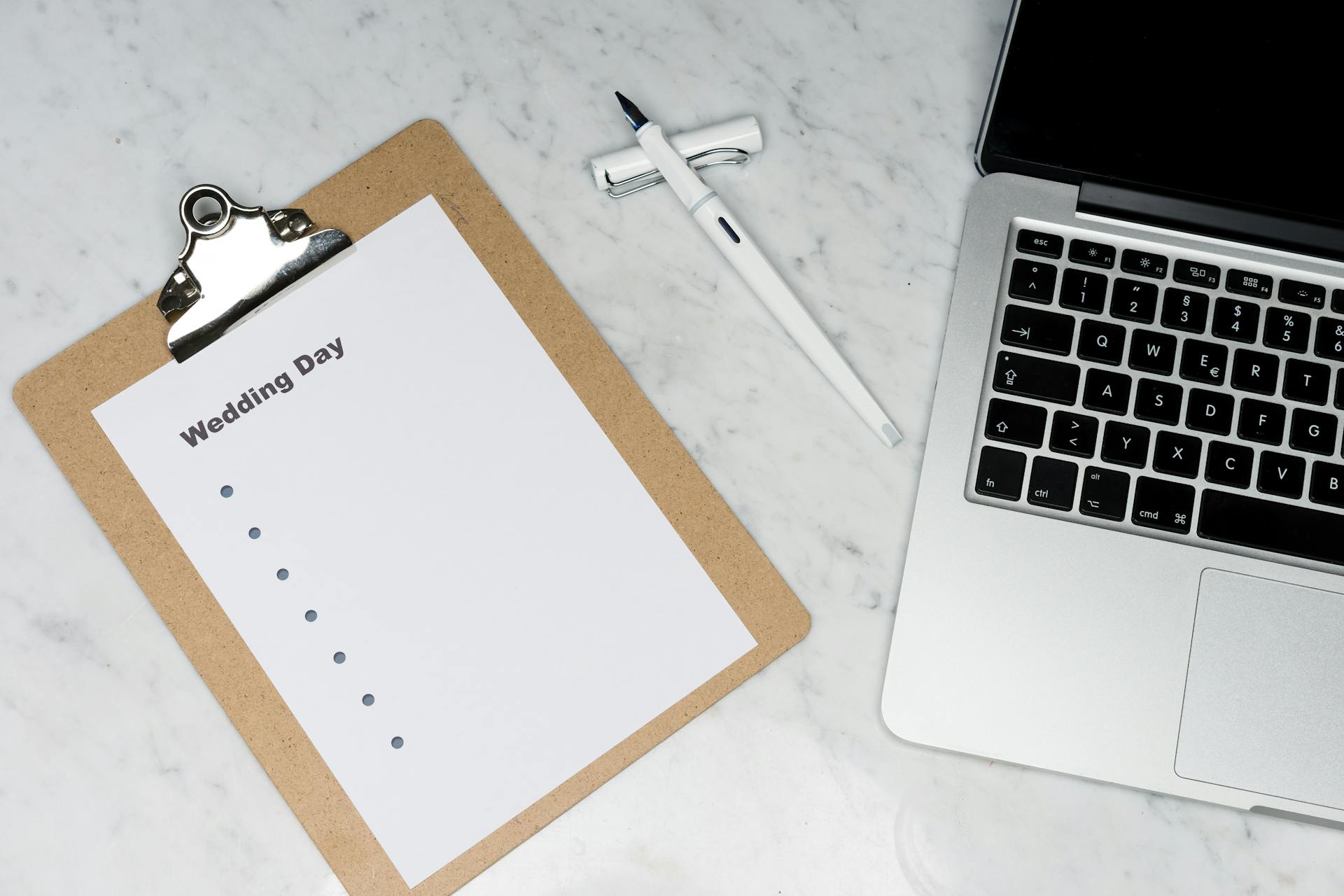 L'ordinateur portable et le bloc-notes d'un organisateur de mariage | Source : Pexels