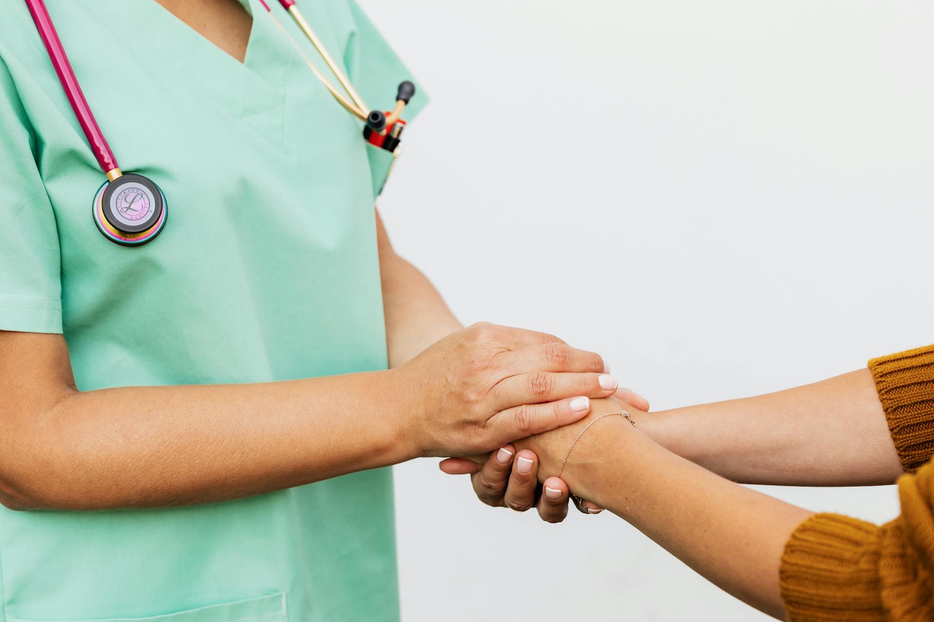 Une infirmière tenant les mains d'un patient | Source : Pexels