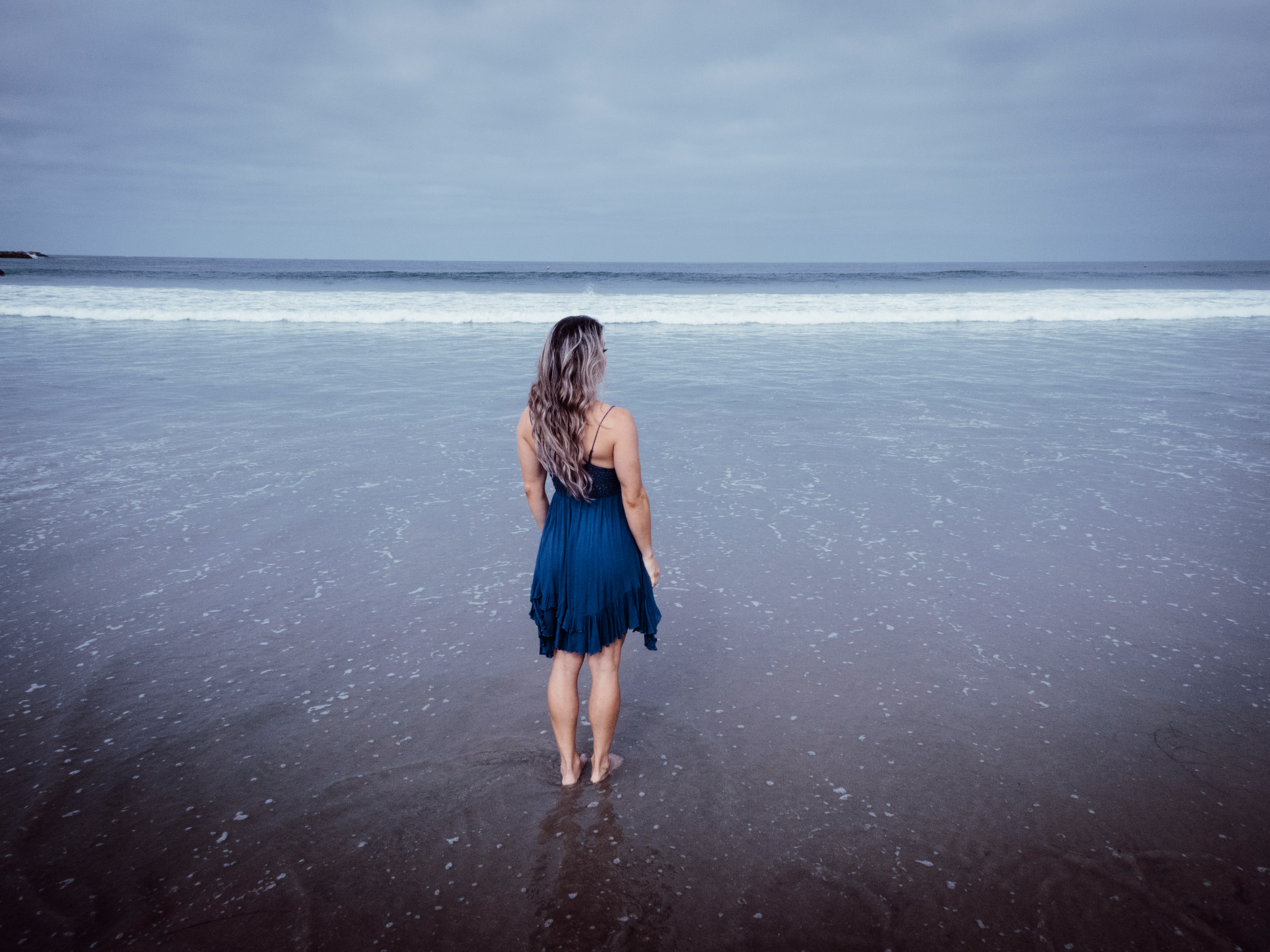 Une femme debout sur une plage | Source : Unsplash
