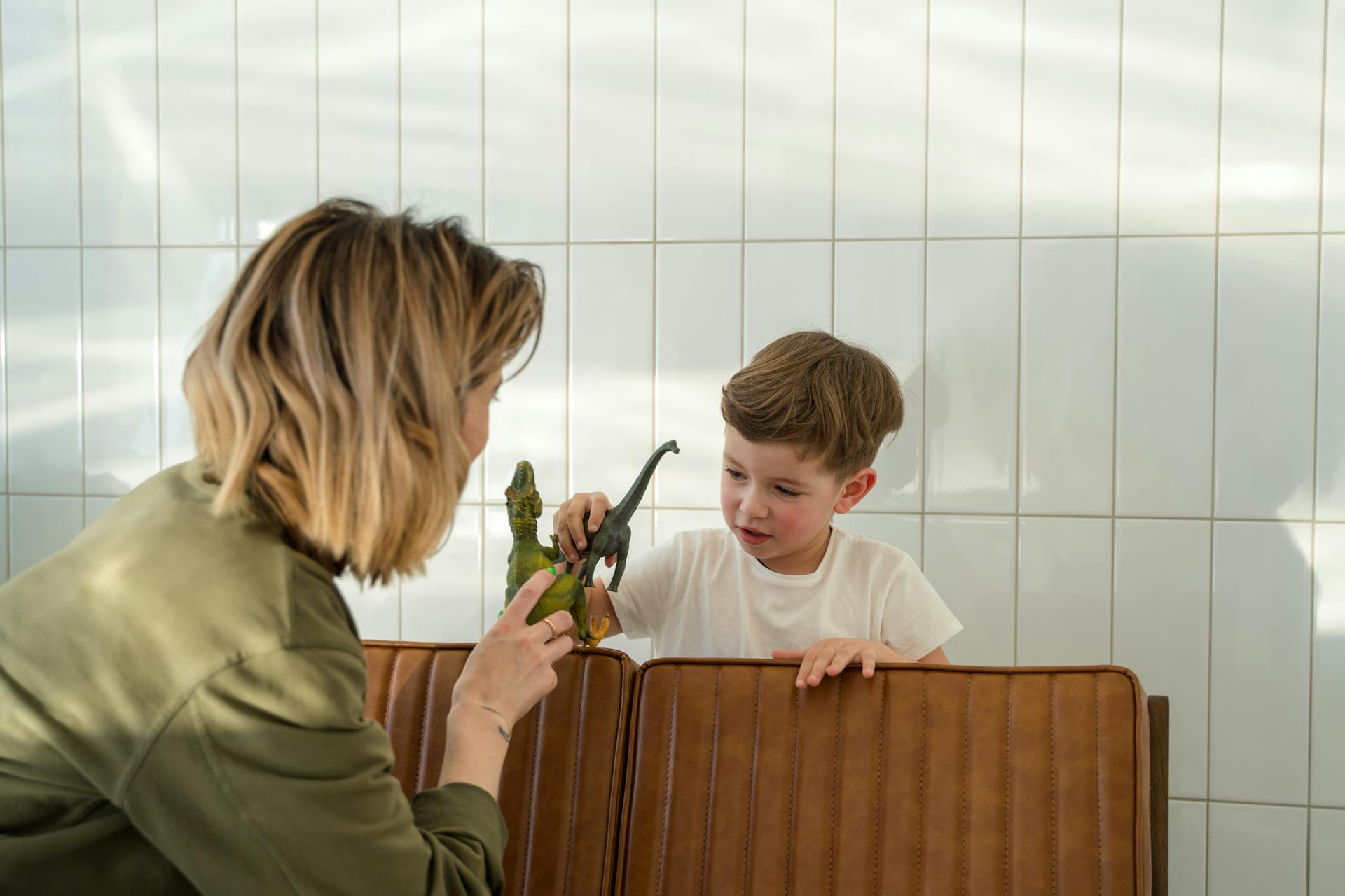 Une femme jouant avec son fils sur un banc | Source : Pexels