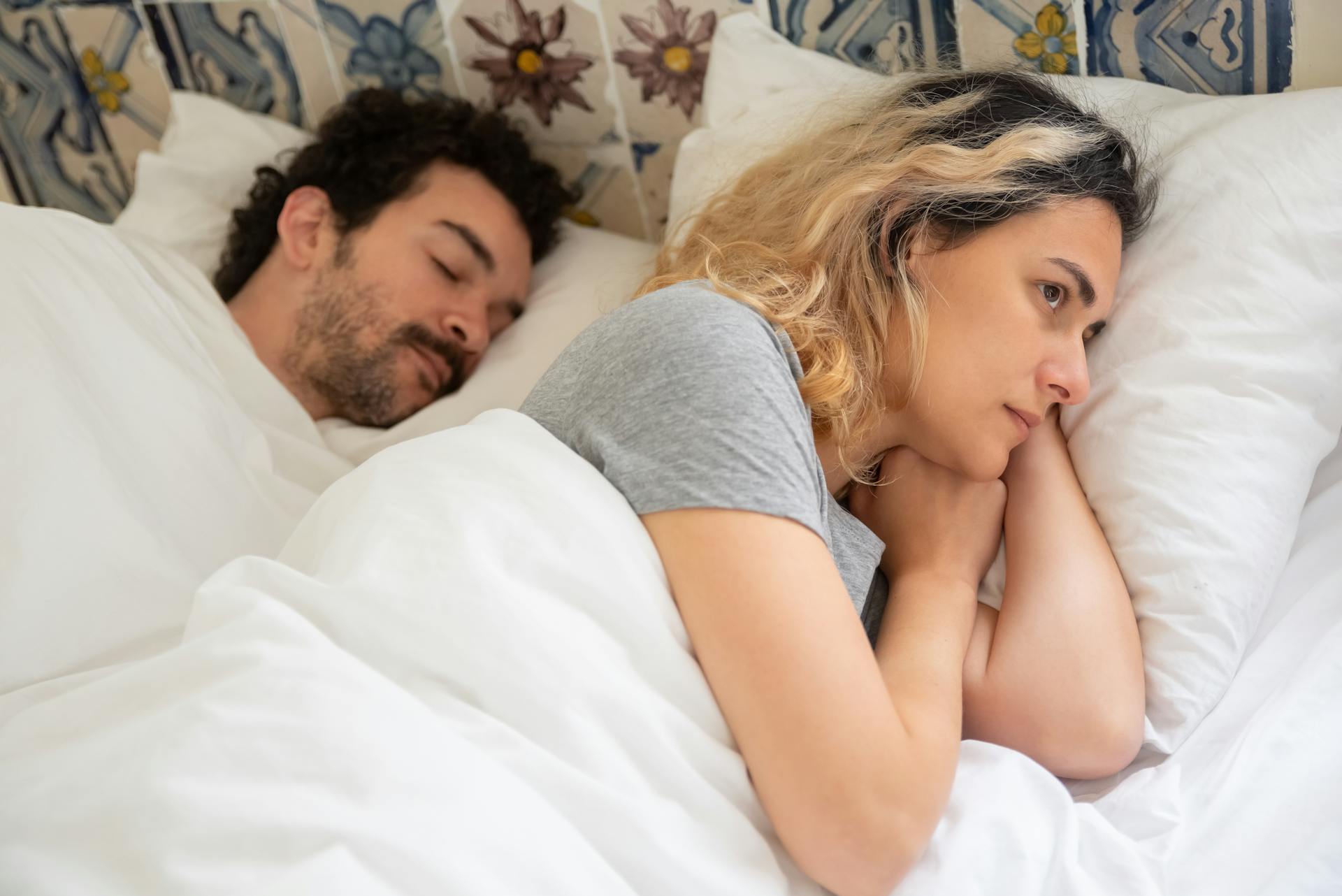 Une femme contemplative allongée éveillée dans son lit | Source : Pexels