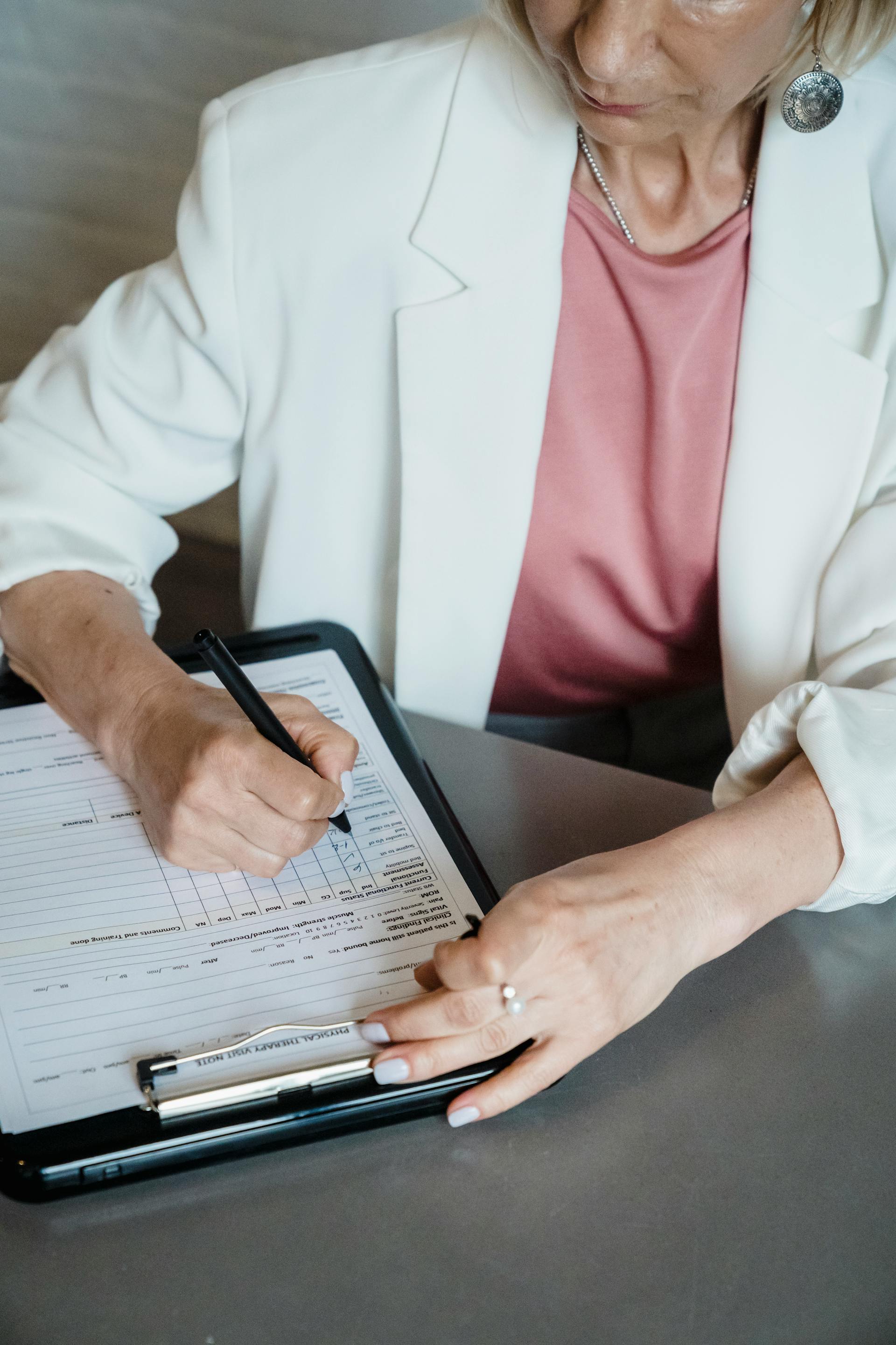 Une femme thérapeute remplit un document | Source : Pexels