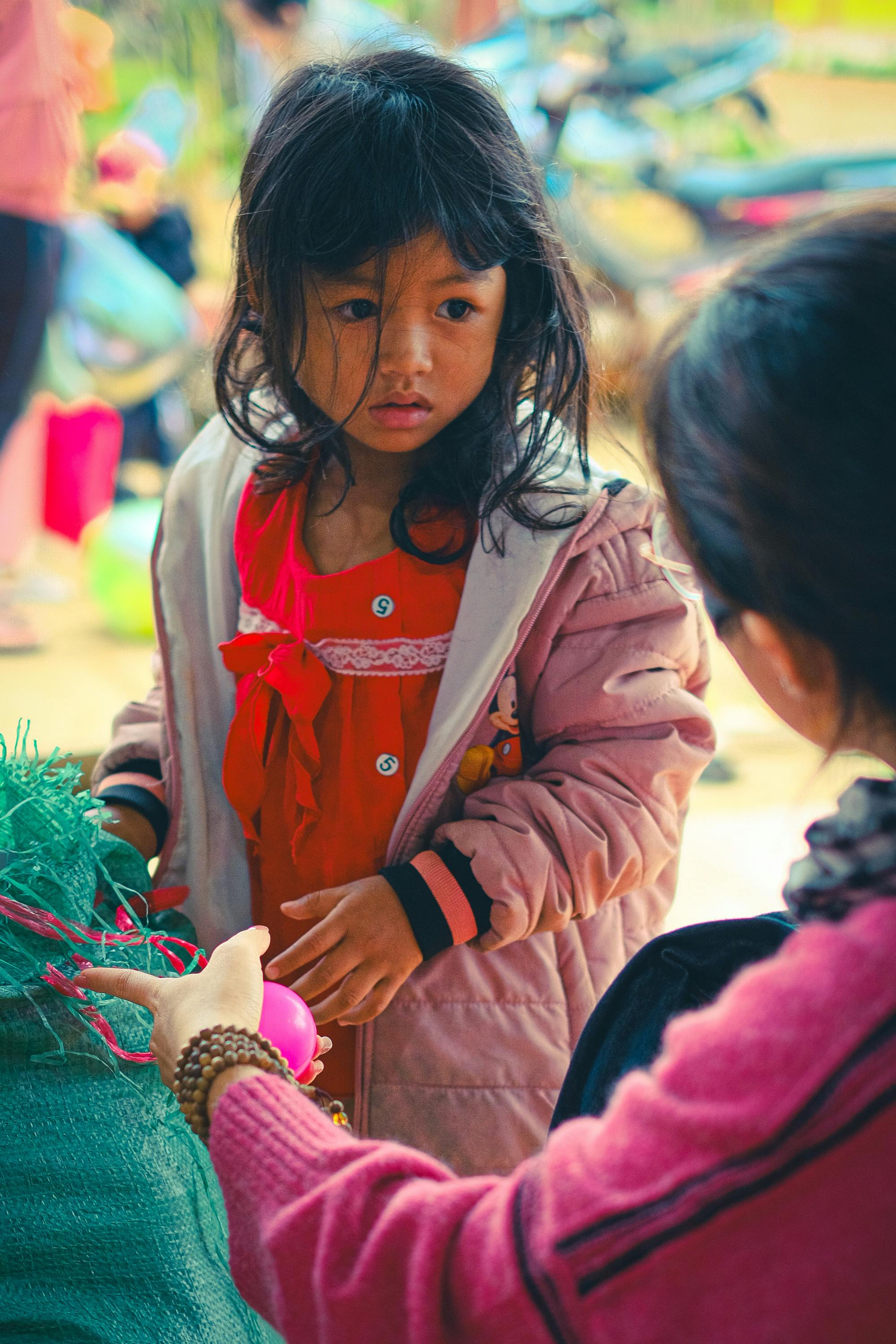 Une petite fille effrayée écoute une femme lui parler | Source : Pexels