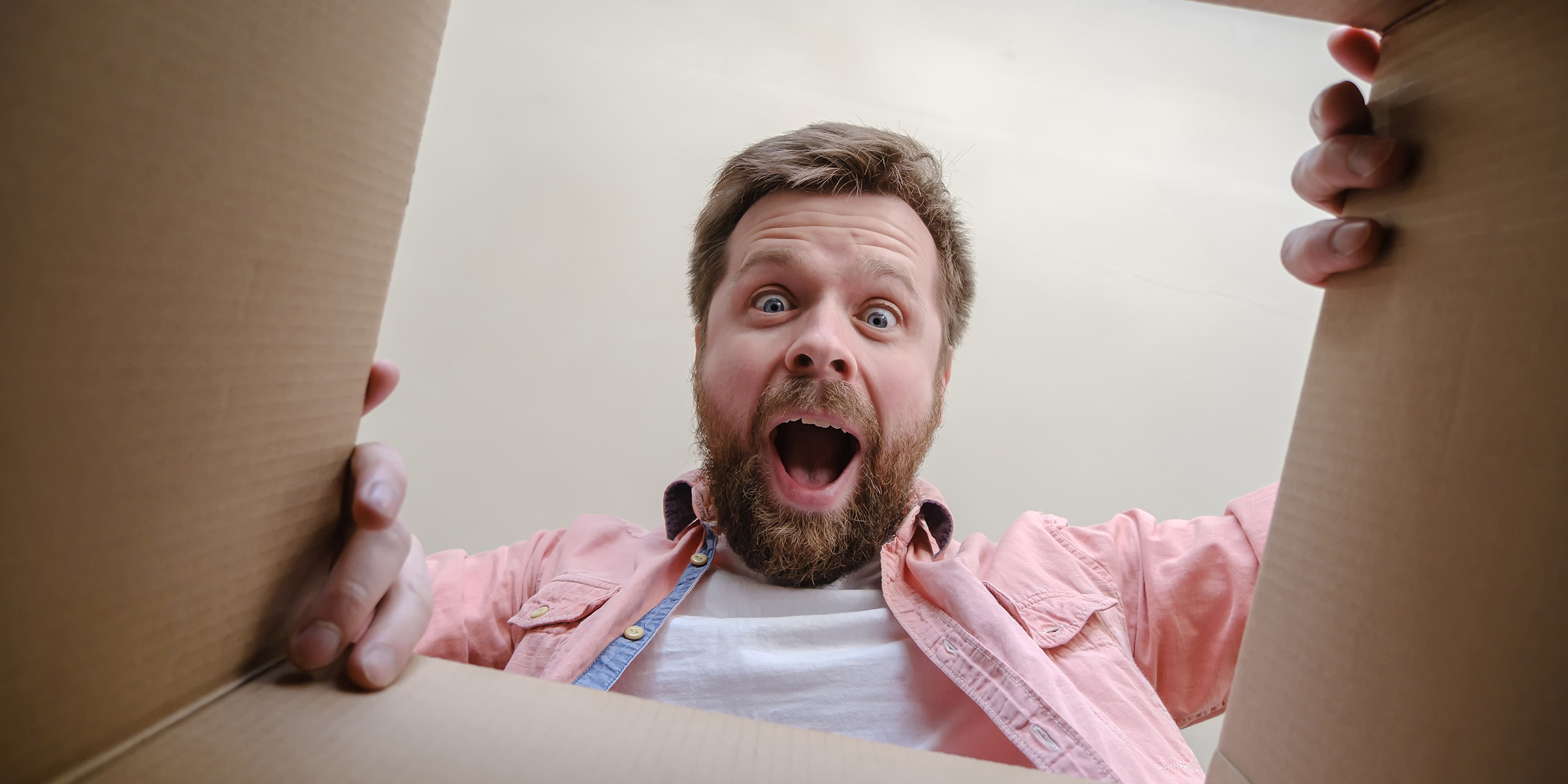 Un homme surpris en train d'ouvrir un cadeau | Source : Shutterstock