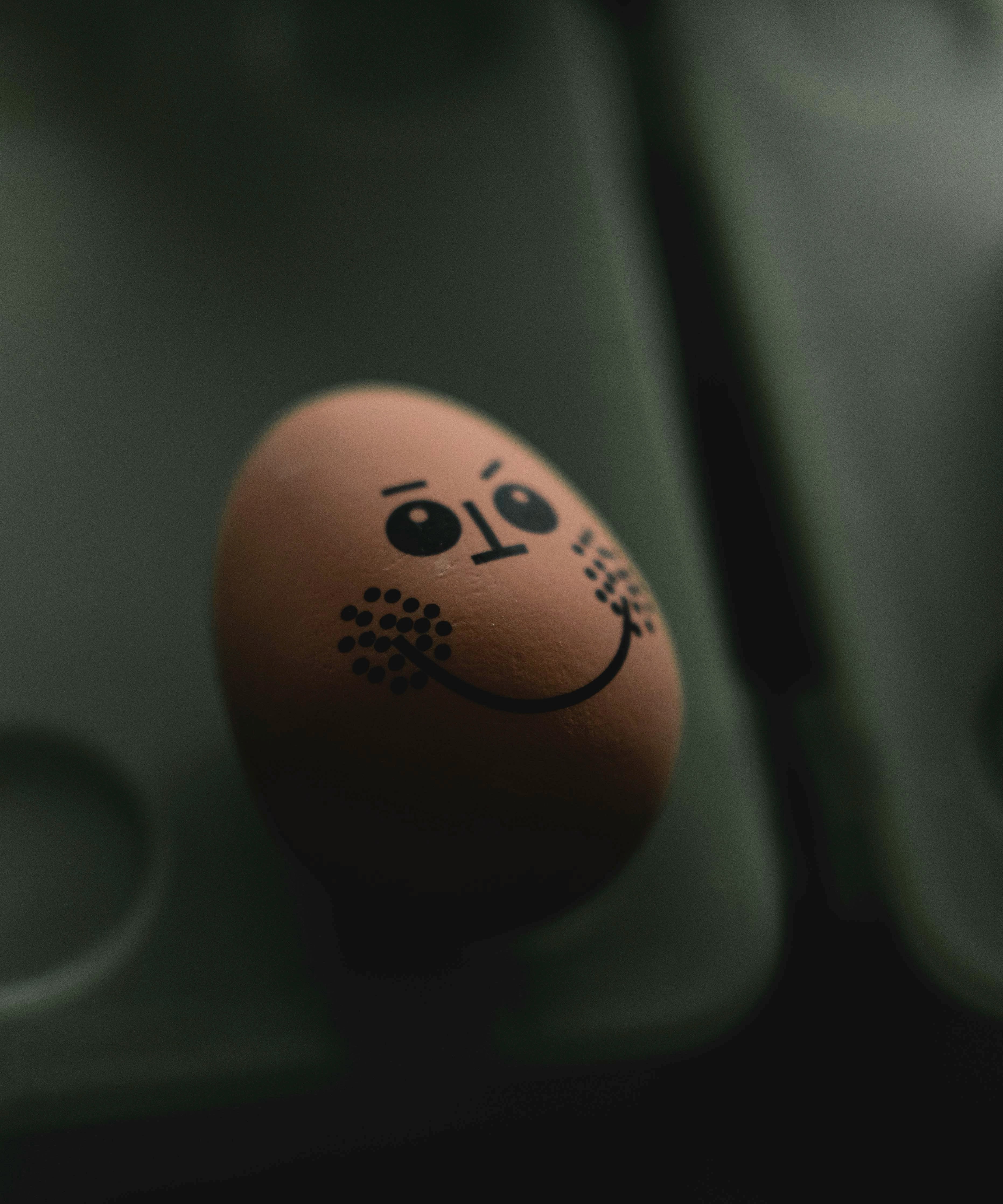 Gros plan d'un œuf sur une surface noire | Source : Unsplash