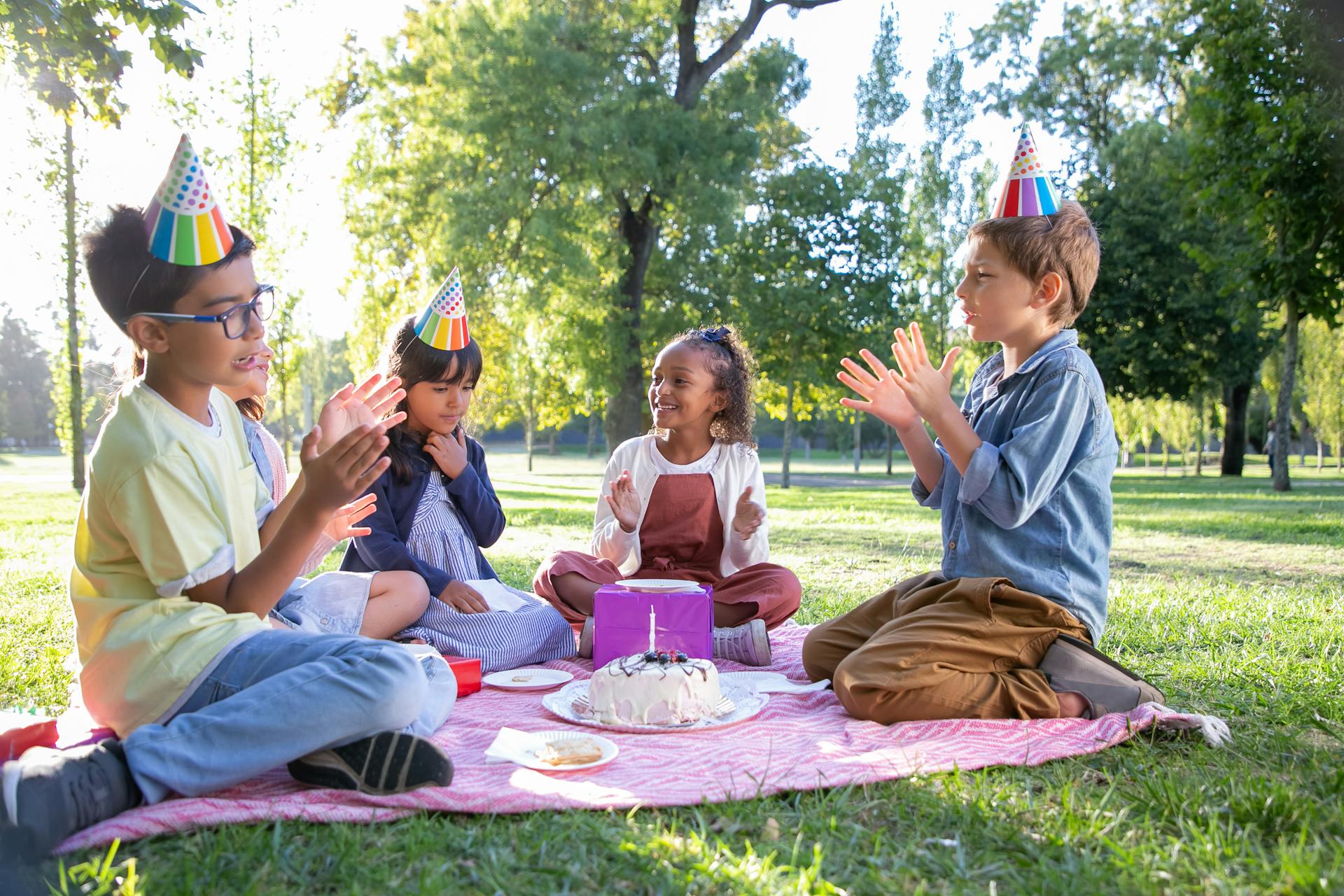 Des enfants portant des chapeaux de fête et applaudissant | Source : Pexels