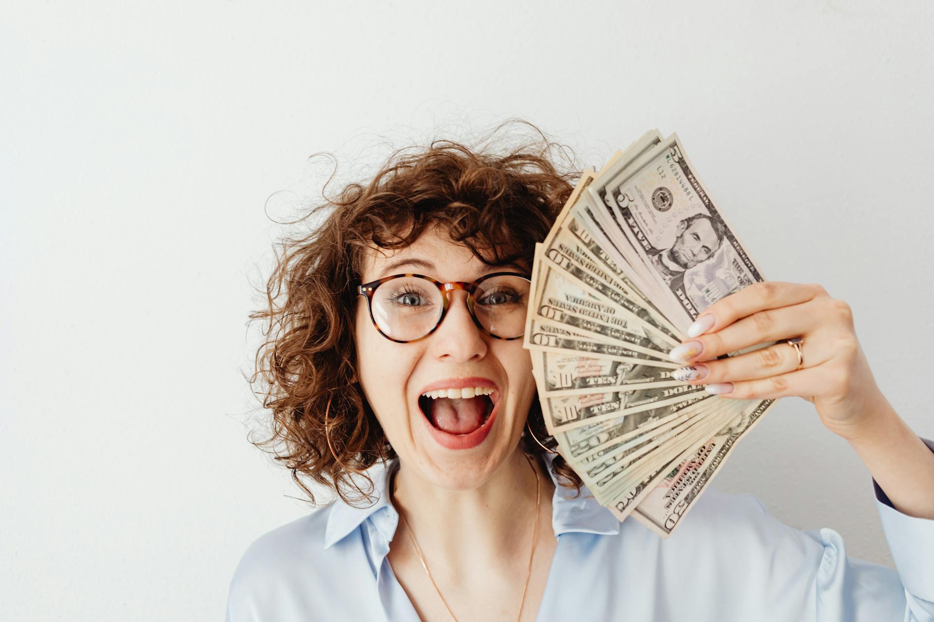 Une femme brandissant de l'argent | Source : Pexels