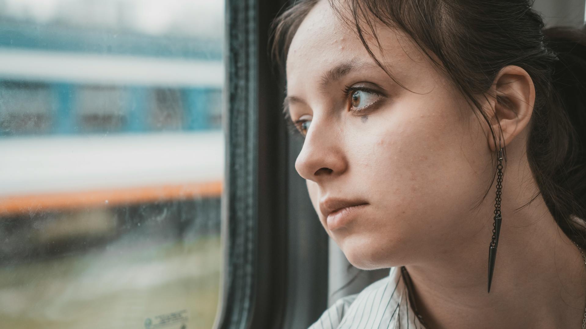 Une femme qui regarde avec inquiétude par la fenêtre | Source : Pexels