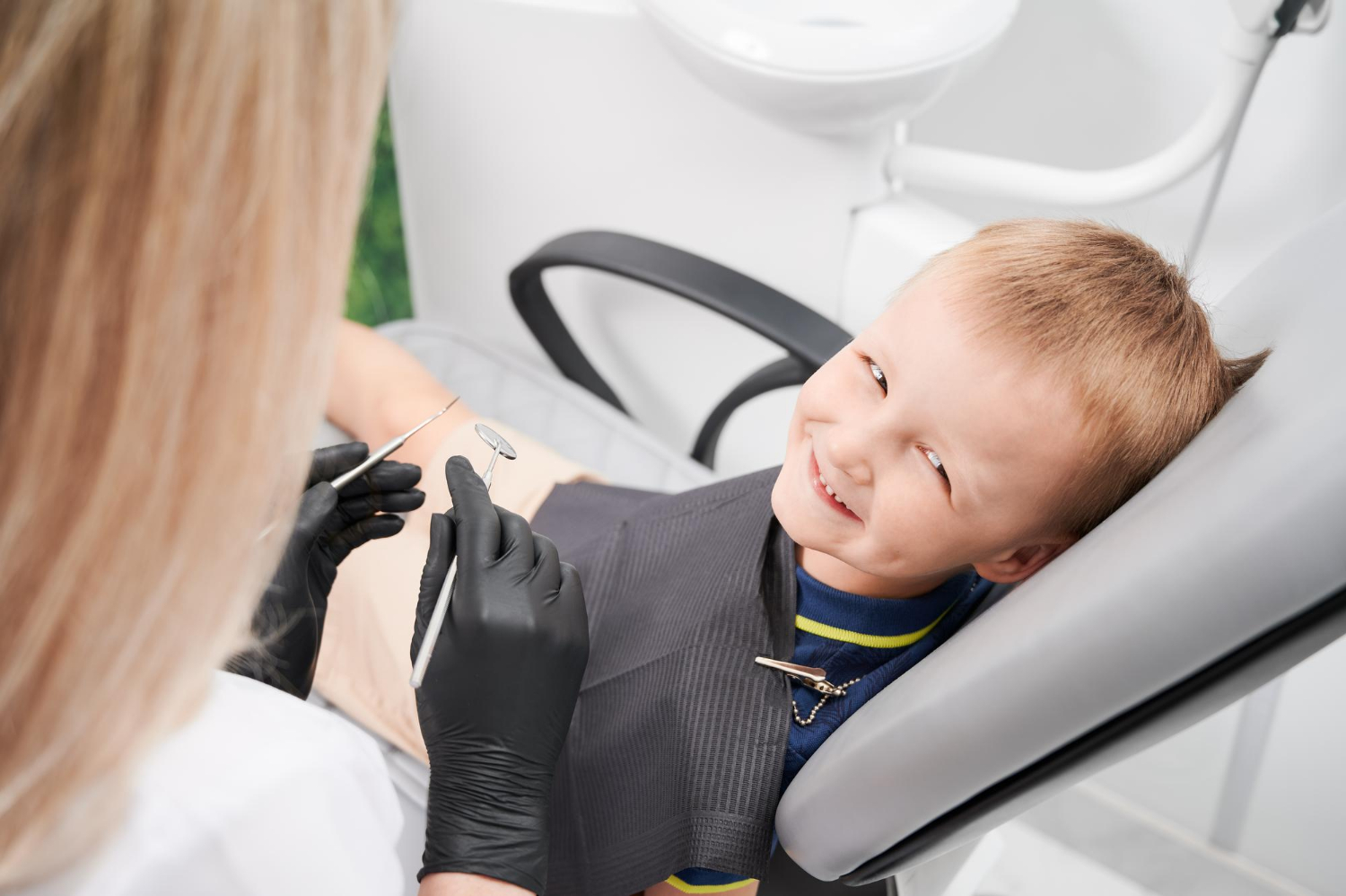 Un petit garçon assis sur un fauteuil dentaire | Source : Freepik