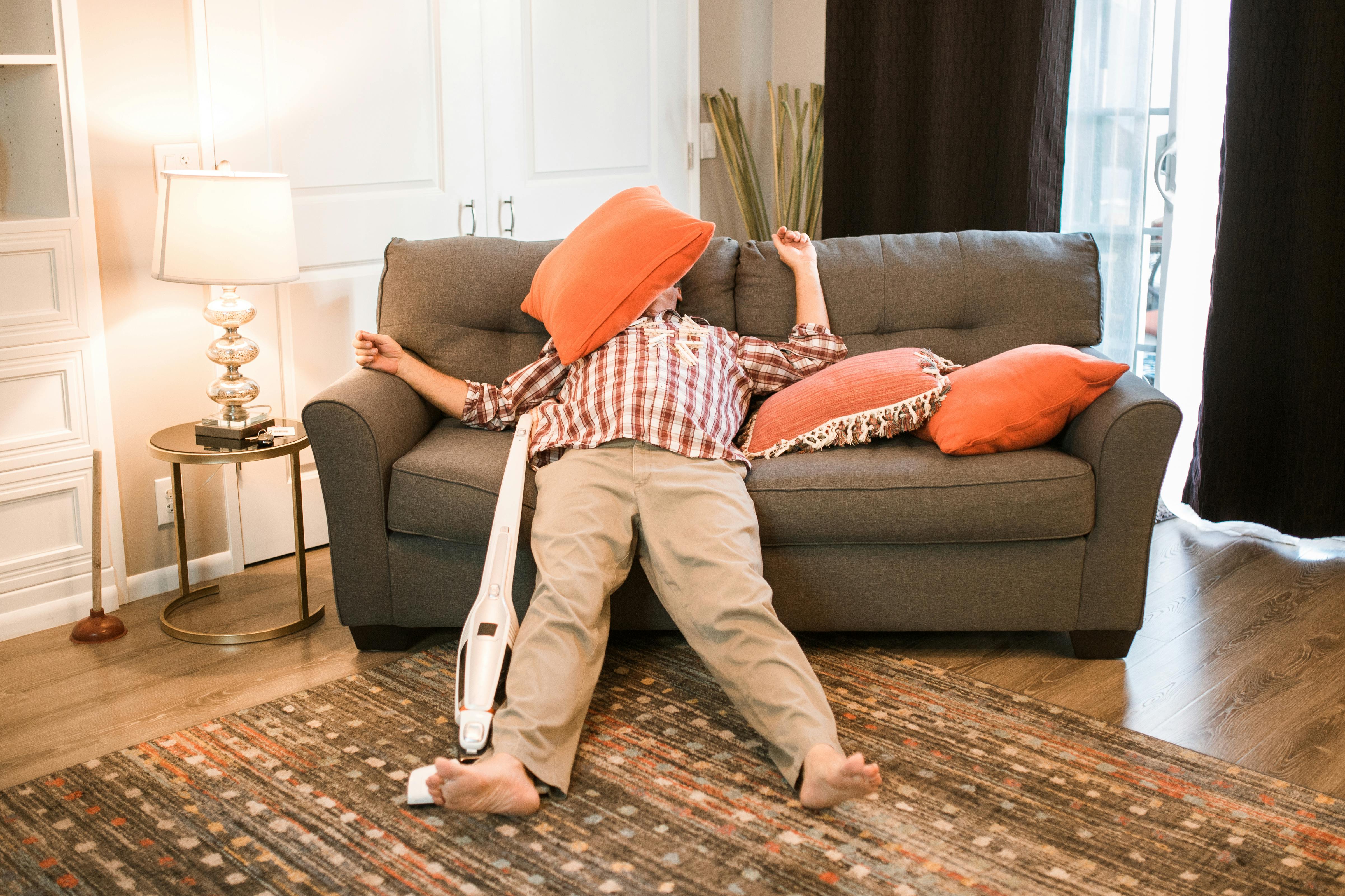 Homme fatigué allongé sur un canapé | Source : Pexels