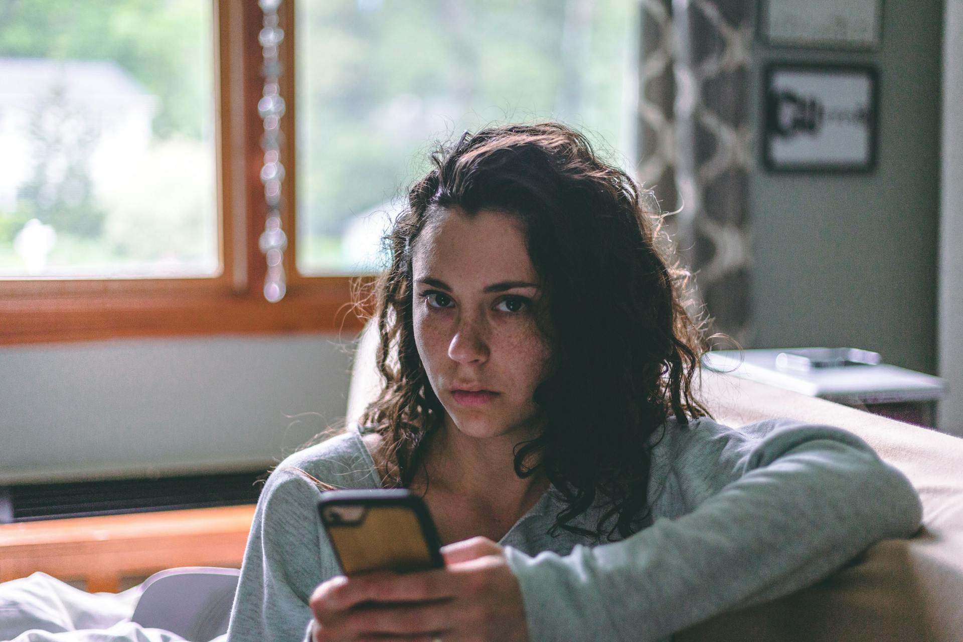 Une femme tenant un téléphone portable | Source : Pexels