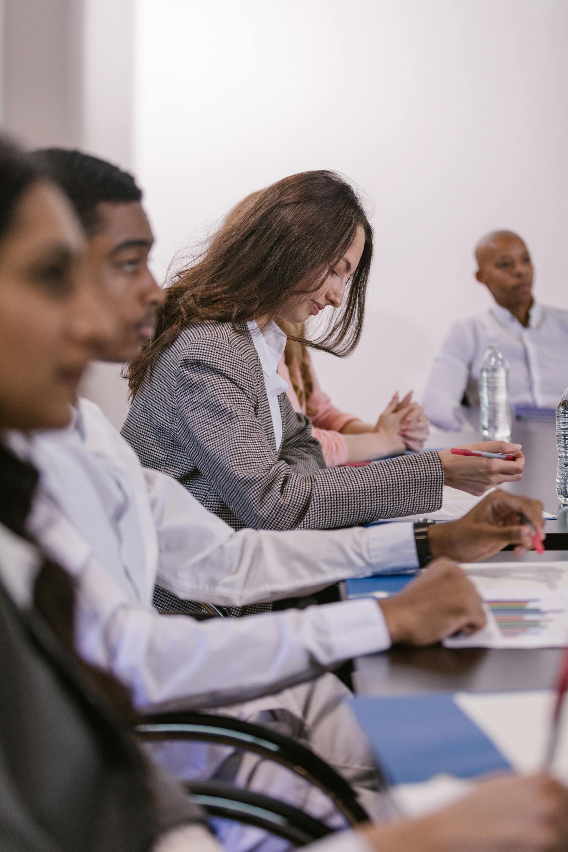 Employés de bureau assis à une table de conférence | Source : Pexels