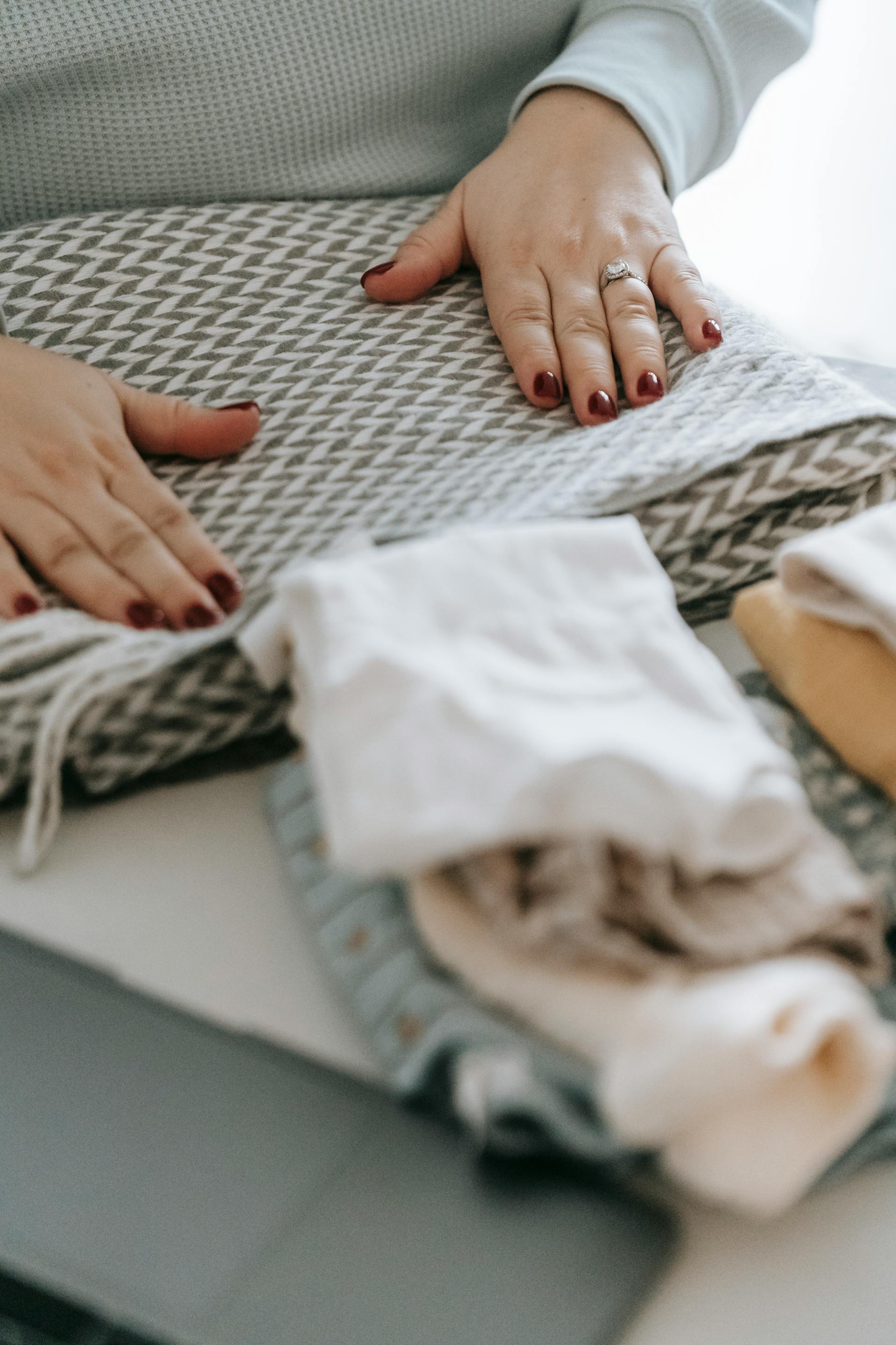 Gros plan sur une femme en train de plier du linge | Source : Pexels