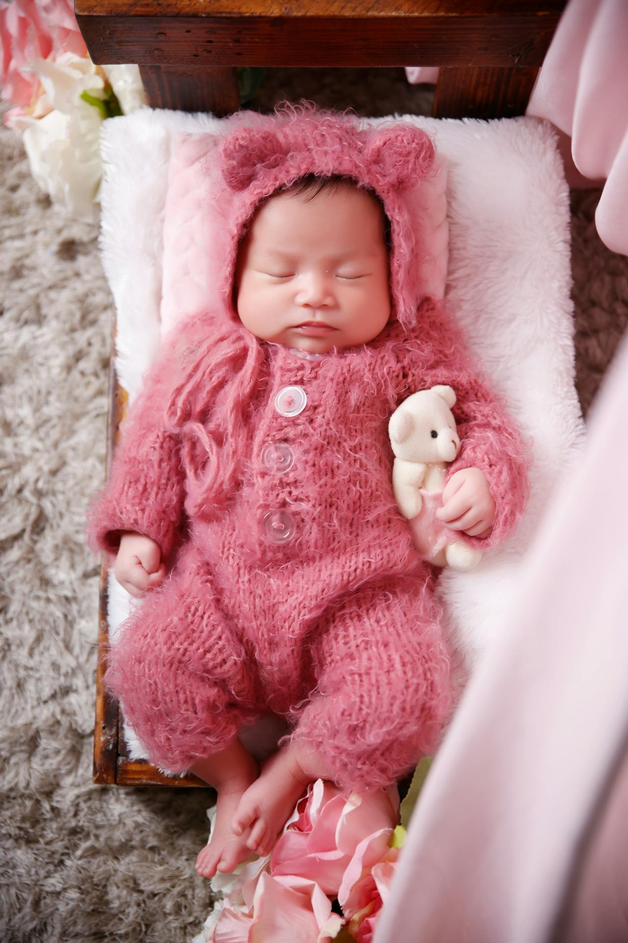 Un adorable bébé endormi dans les bras d'un ours en peluche | Source : Pexels