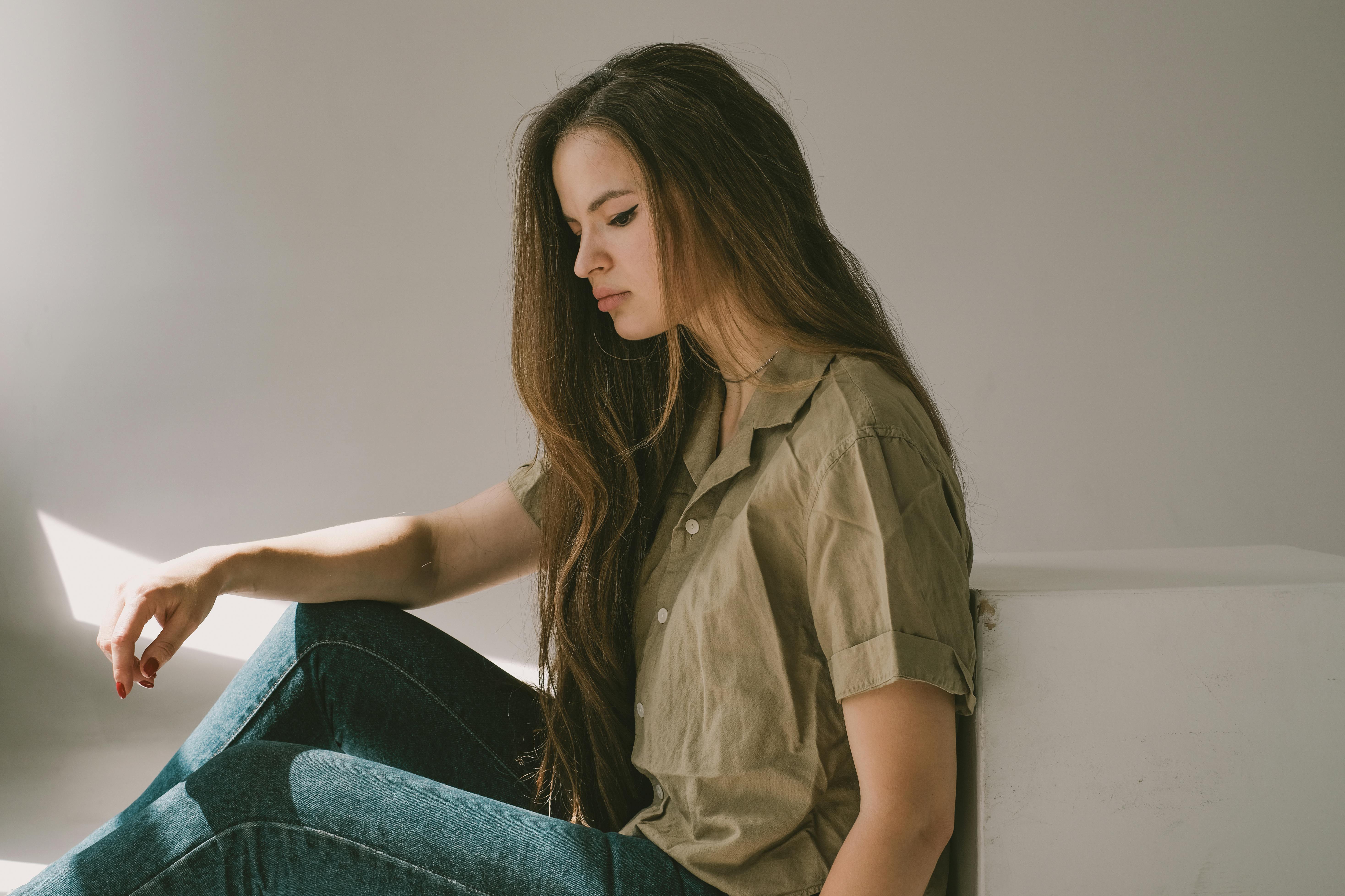 Femme triste assise sur le sol | Source : Pexels